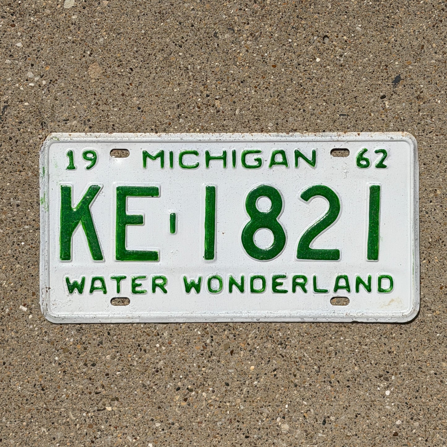 Photo of a 1962 Michigan License Plate Auto Tag Garage Decor Vintage KE 1821 with original patina