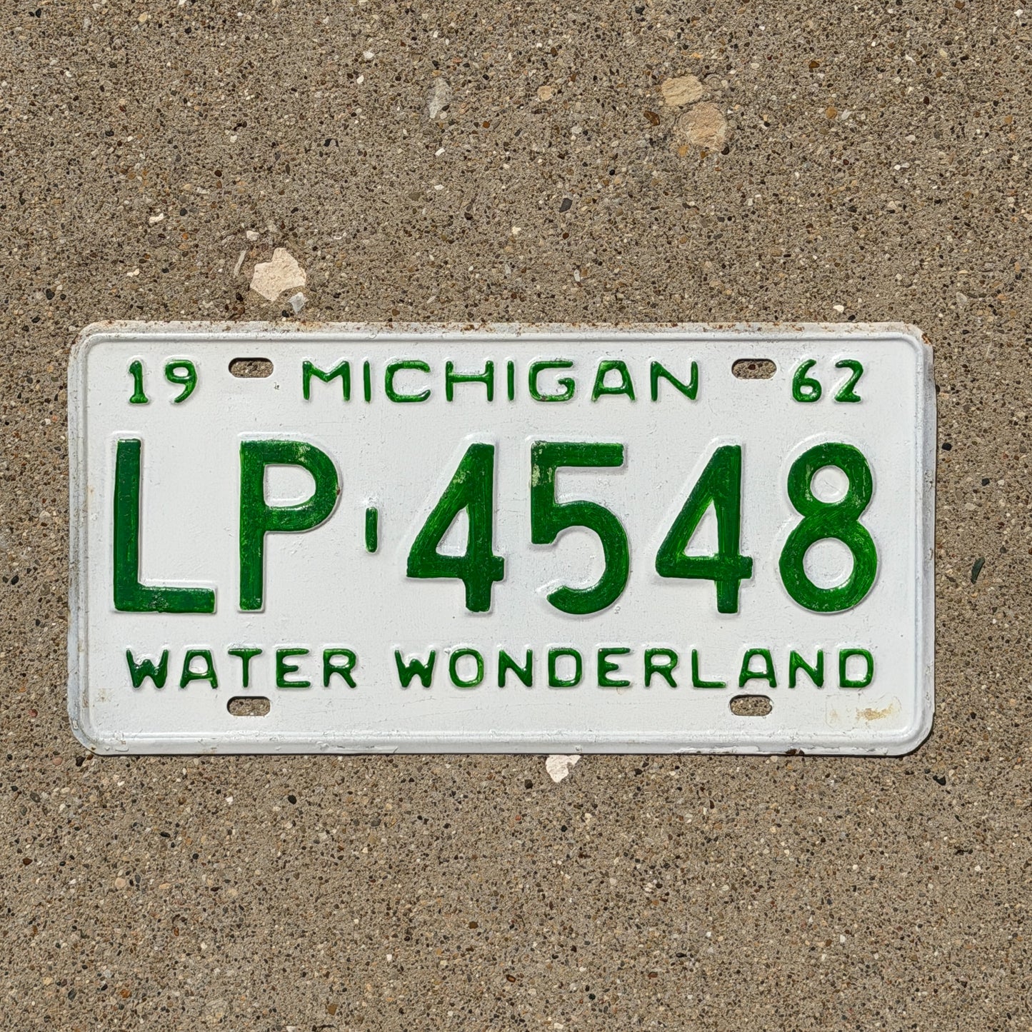 Photo of a 1962 Michigan License Plate Auto Tag Garage Decor Vintage LP 4548 with original patina