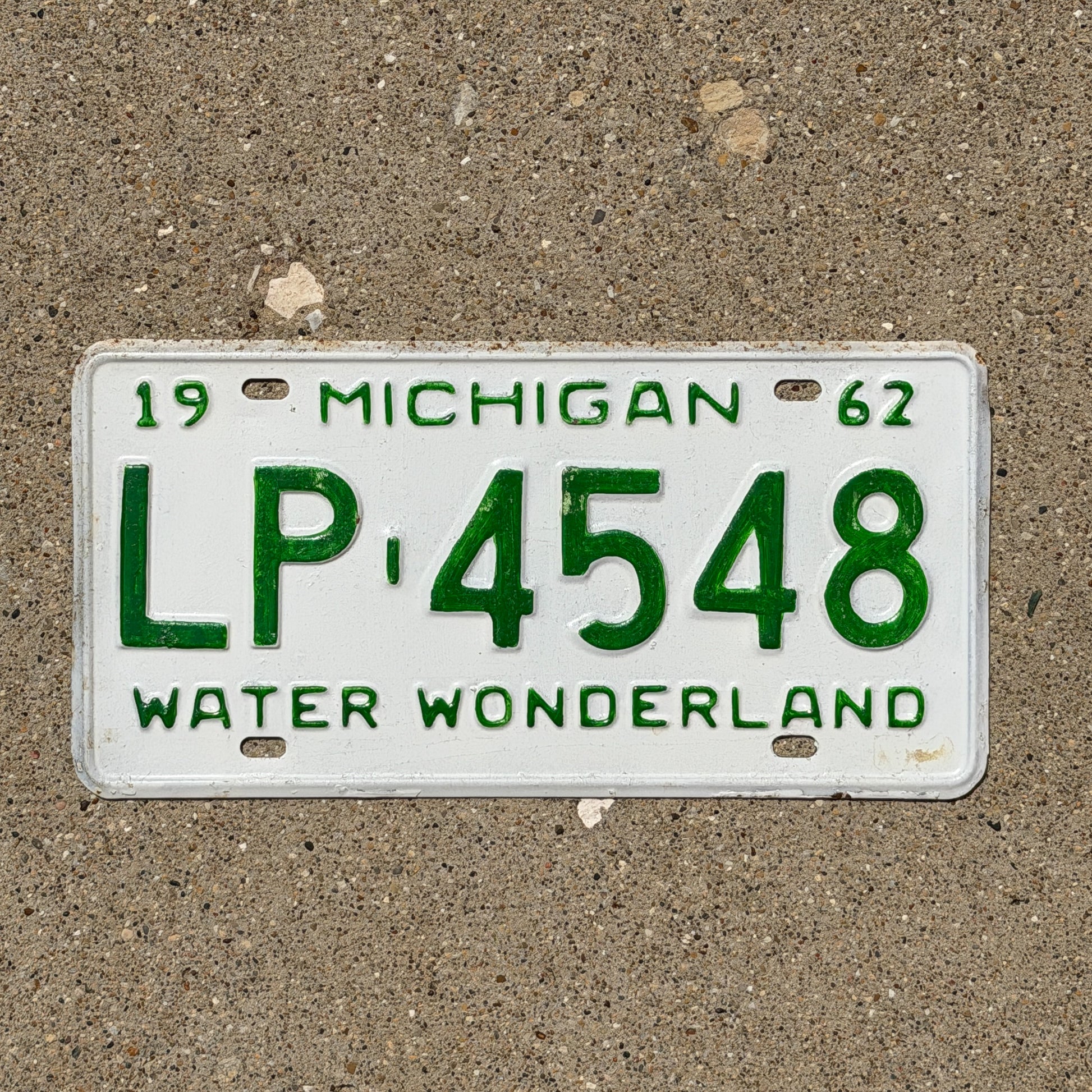 Photo of a 1962 Michigan License Plate Auto Tag Garage Decor Vintage LP 4548 with original patina