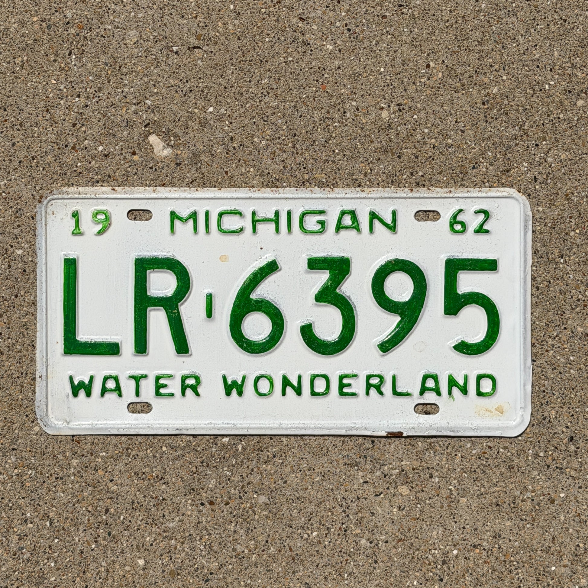 Photo of a 1962 Michigan License Plate Auto Tag Garage Decor Vintage LR 6395 with original patina