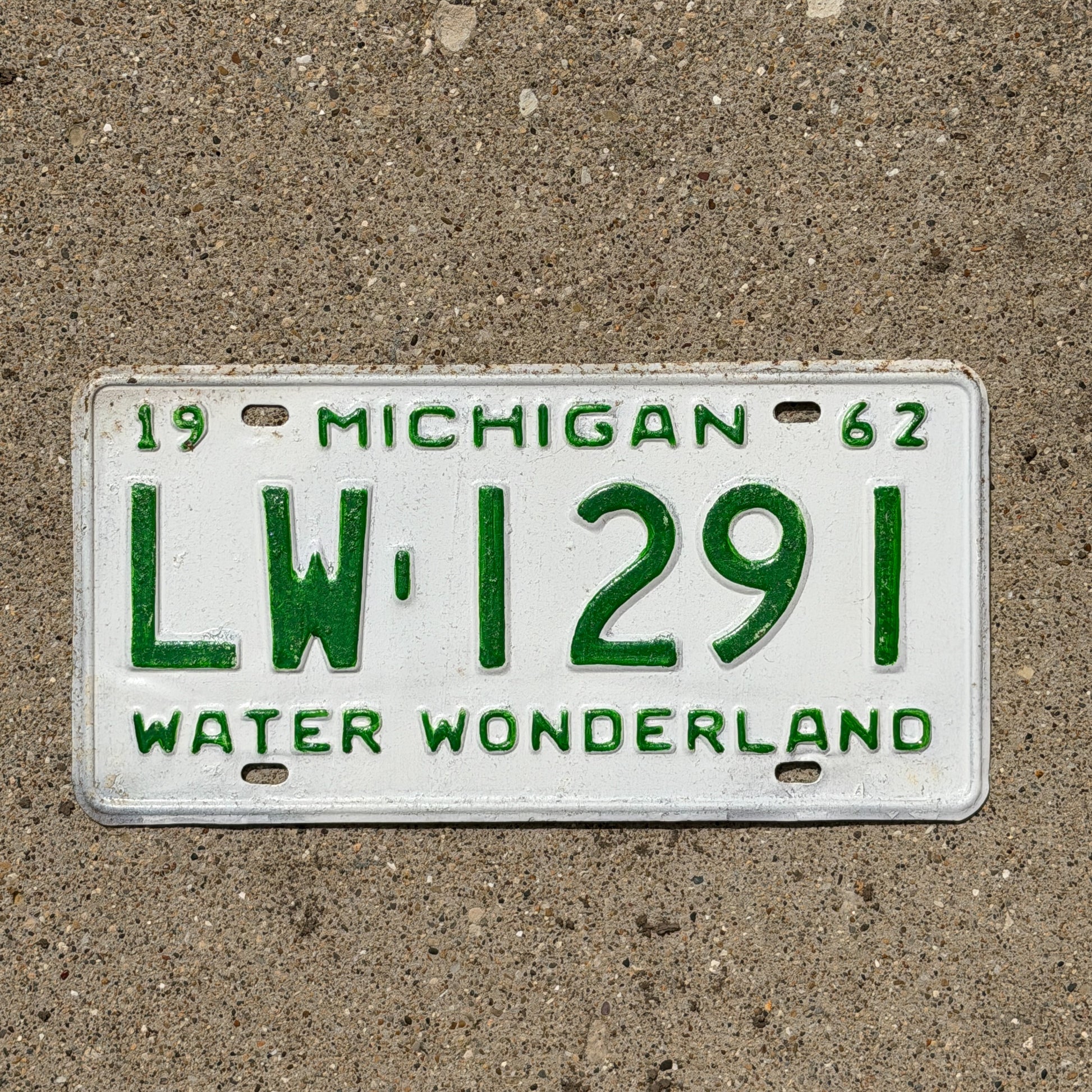 Photo of a 1962 Michigan License Plate Auto Tag Garage Decor Vintage LW 1291 with original patina