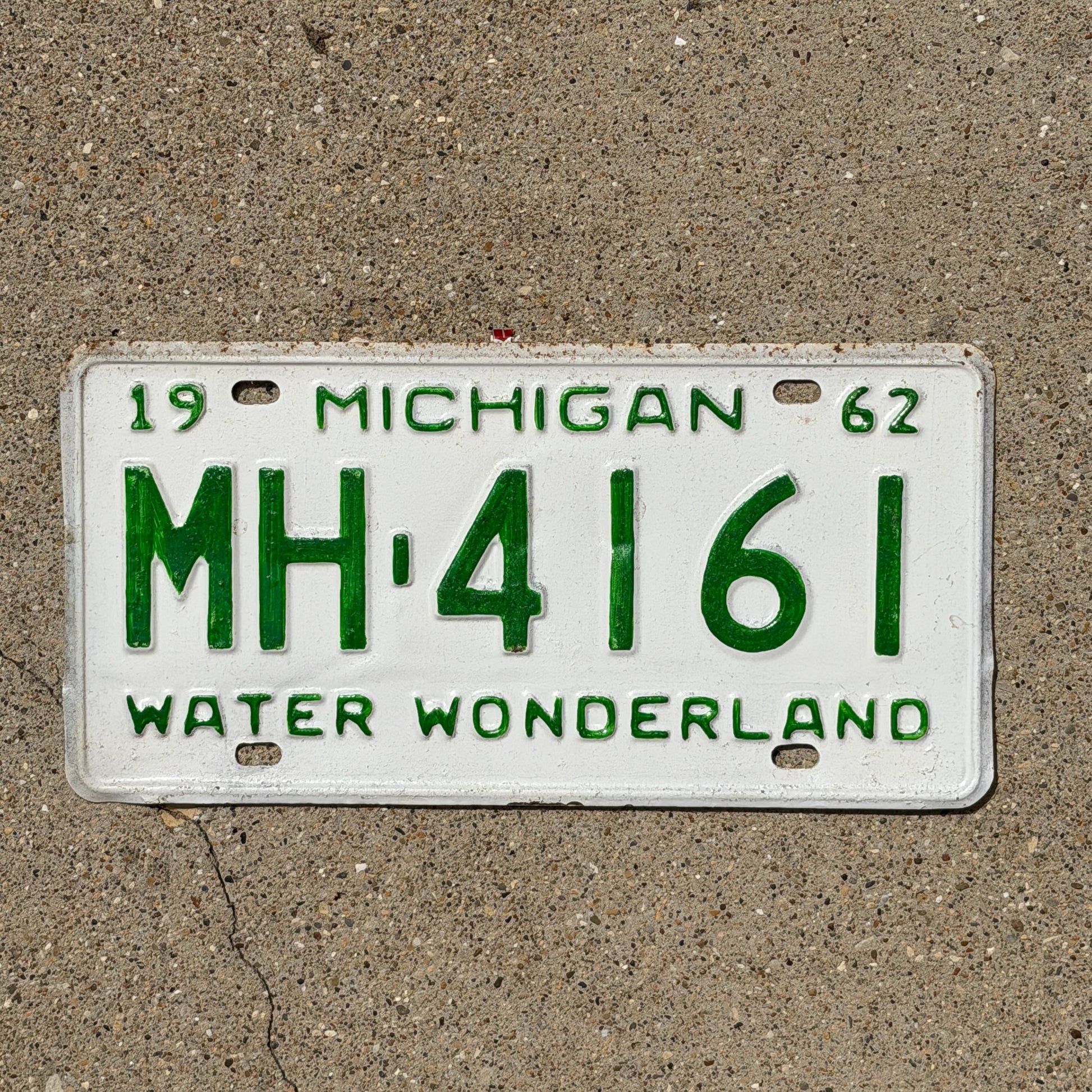 Photo of a 1962 Michigan License Plate Auto Tag Garage Decor Vintage MH 4161 with original patina