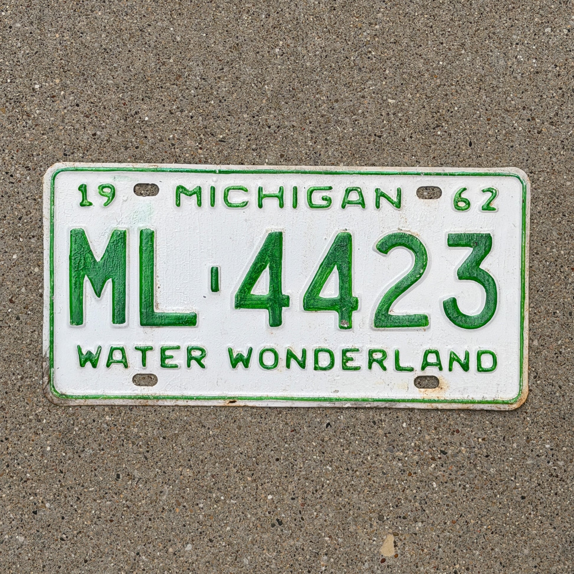 Photo of a 1962 Michigan License Plate Auto Tag Garage Decor Vintage ML 4423 with original patina