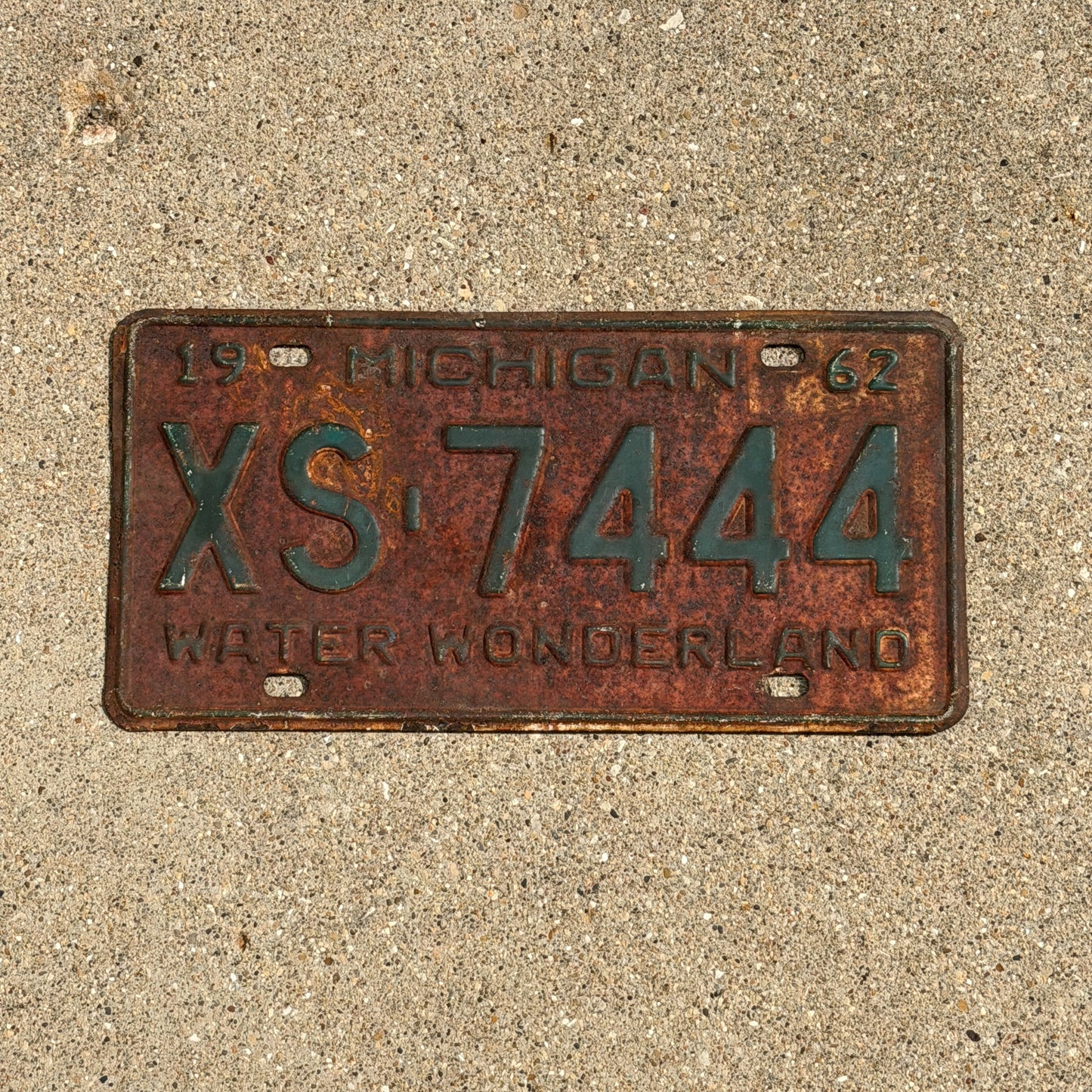 Photo of a 1962 Michigan License Plate Auto Tag Garage Decor Vintage Repeat Repeating XS 7444 with original patina