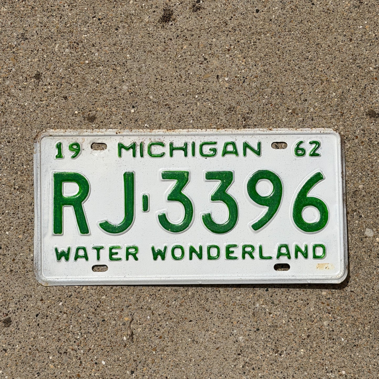 Photo of a 1962 Michigan License Plate Auto Tag Garage Decor Vintage RJ 3396 with original patina