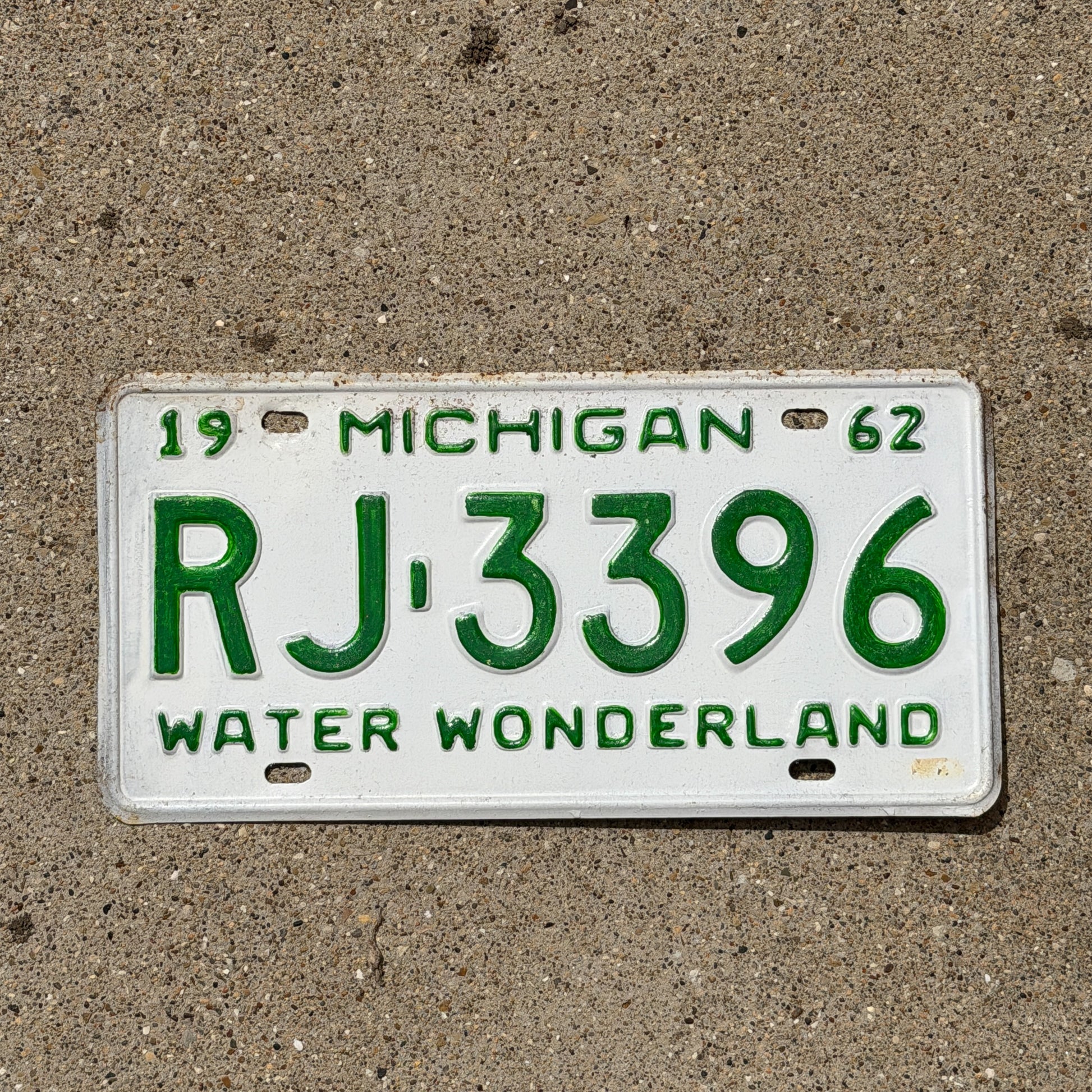 Photo of a 1962 Michigan License Plate Auto Tag Garage Decor Vintage RJ 3396 with original patina