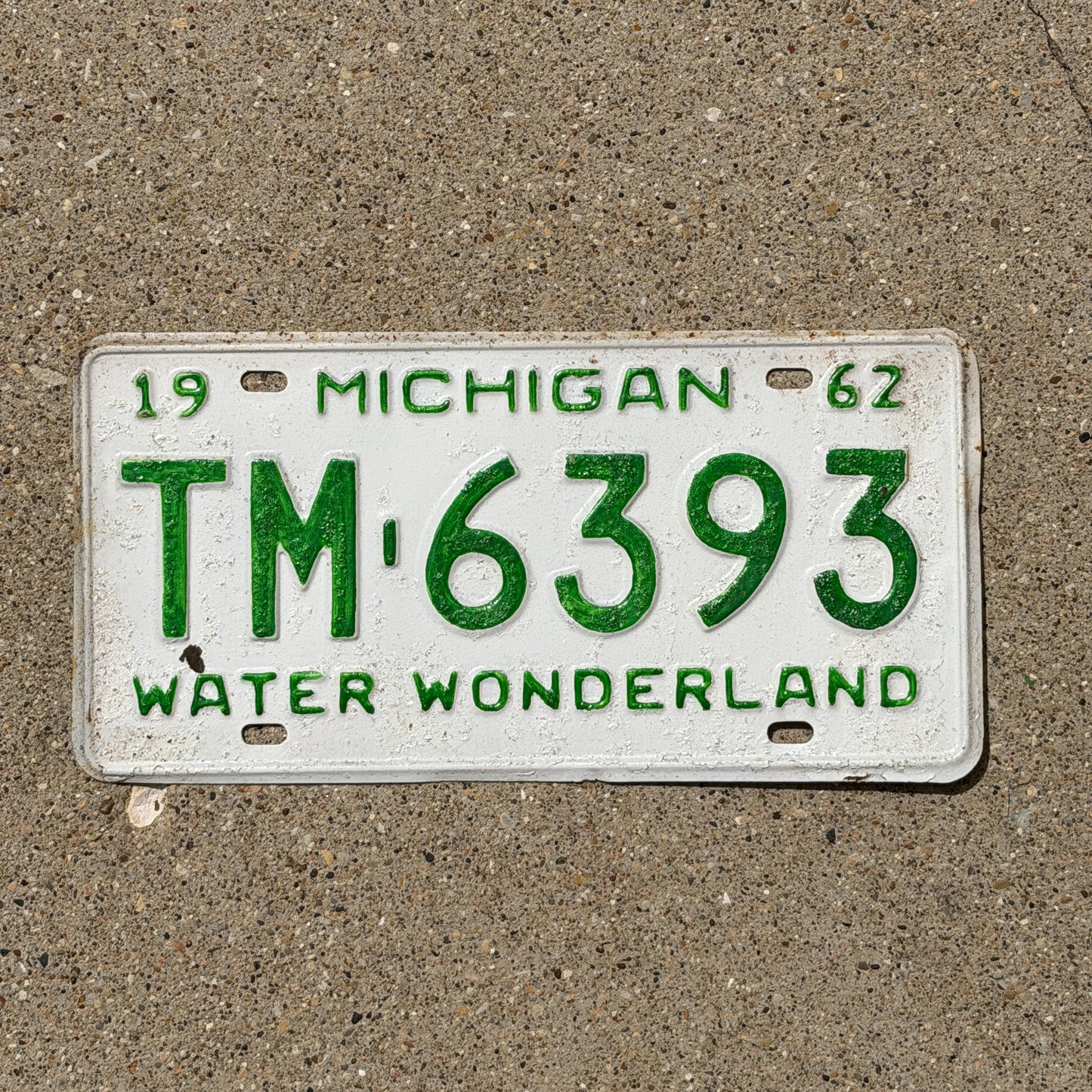 Photo of a 1962 Michigan License Plate Auto Tag Garage Decor Vintage TM 6393 with original patina