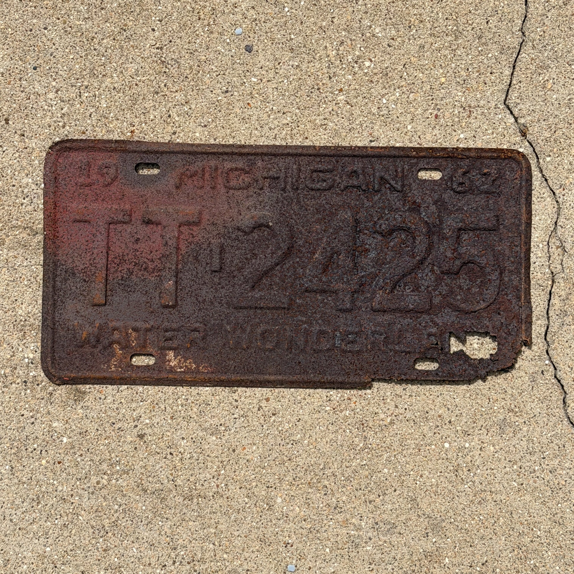 Photo of a 1962 Michigan License Plate Auto Tag Garage Decor Vintage TT 2425 with original patina