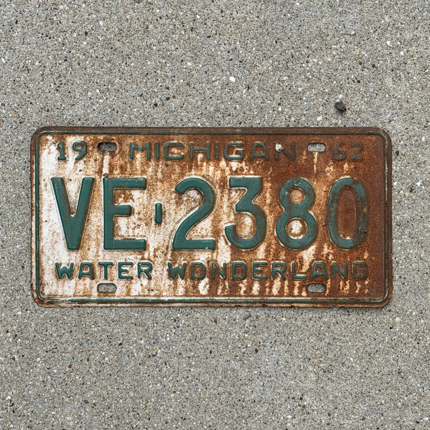Photo of a 1962 Michigan License Plate Auto Tag Garage Decor Vintage VE 2380 with original patina