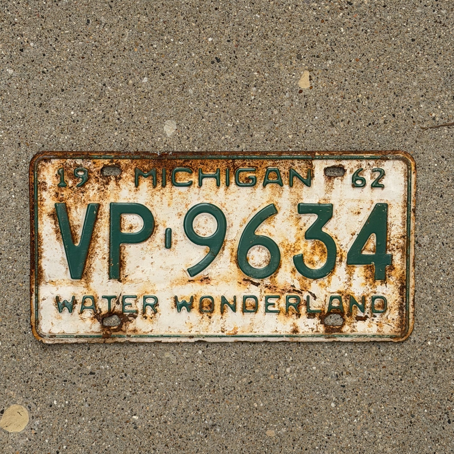 Photo of a 1962 Michigan License Plate Auto Tag Garage Decor Vintage VP 9634 with original patina