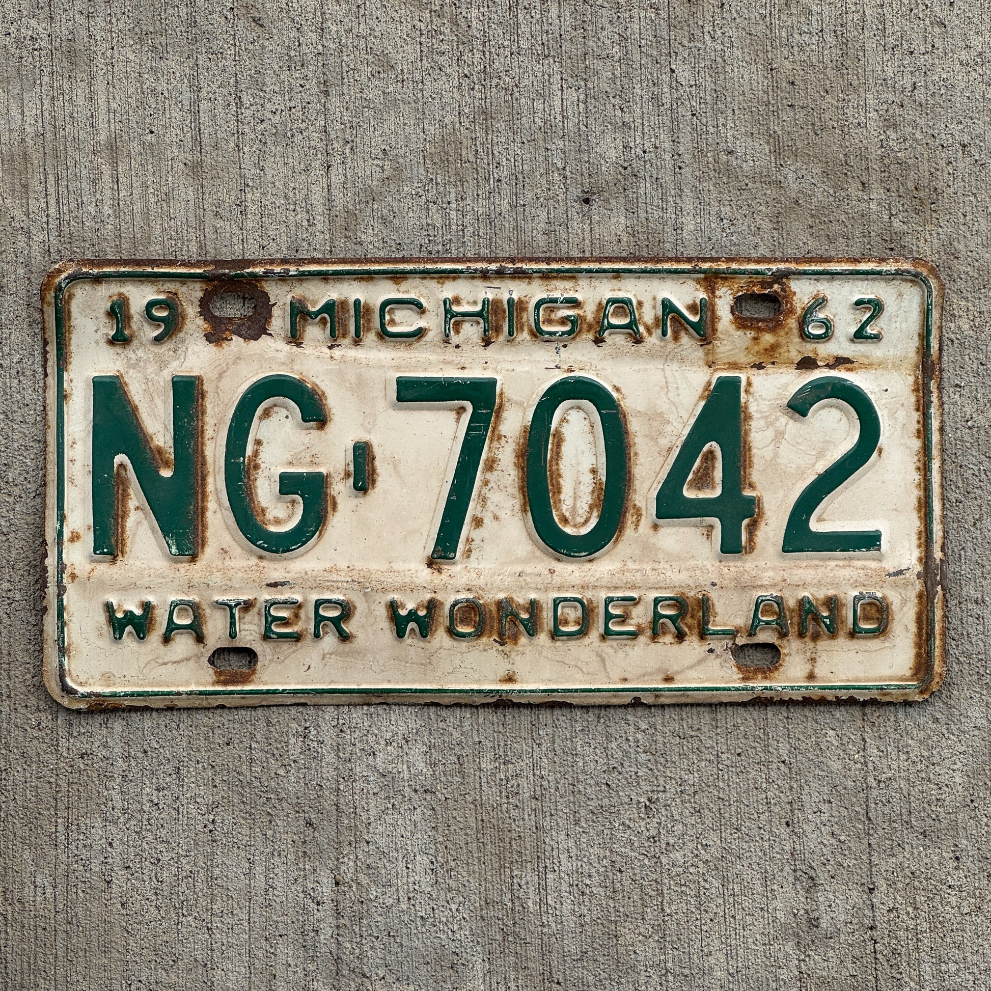 Photo of a 1962 Michigan License Plate Auto Tag Garage Decor Vintage Washtenaw County NG 7042 with original patina