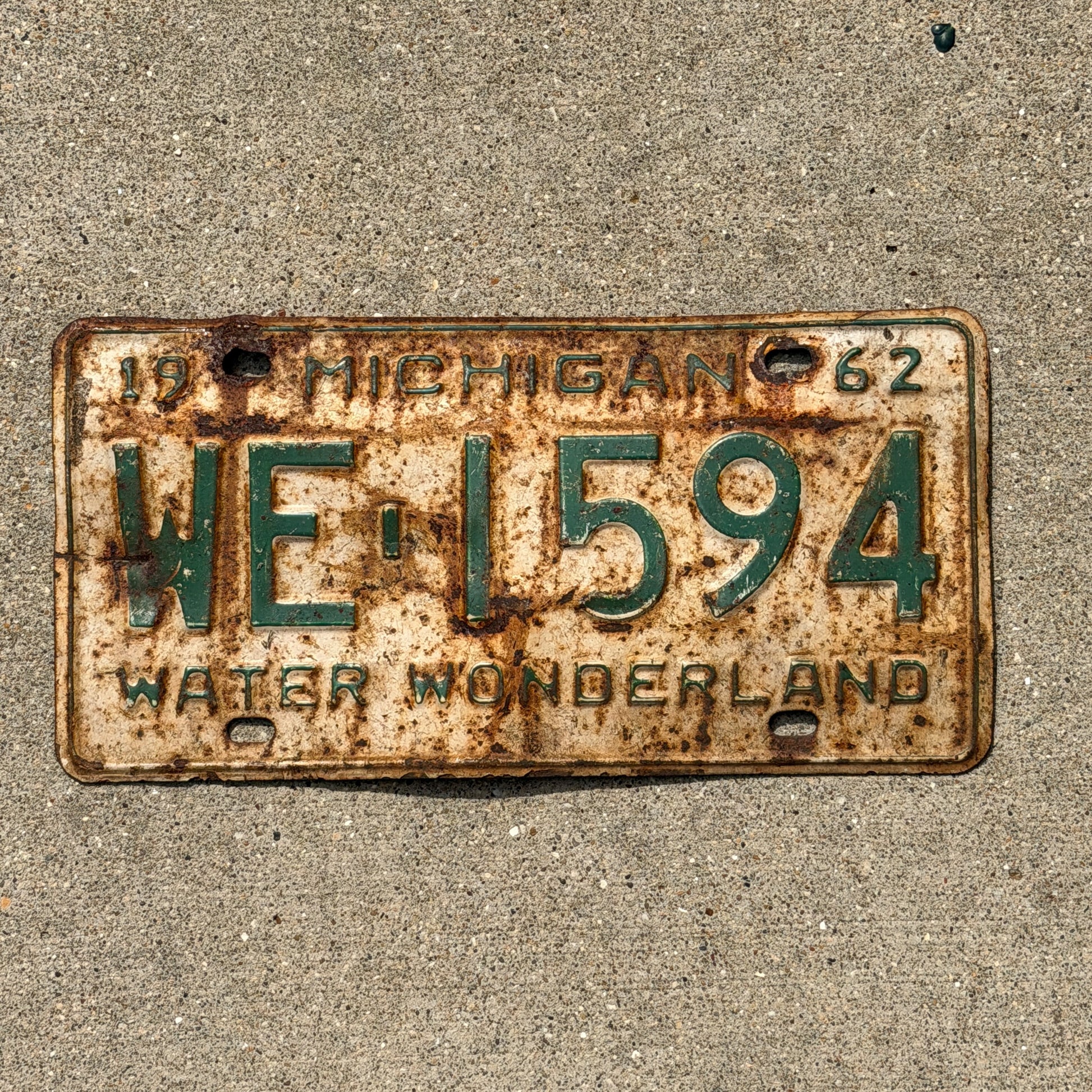Photo of a 1962 Michigan License Plate Auto Tag Garage Decor Vintage WE 1594 with original patina