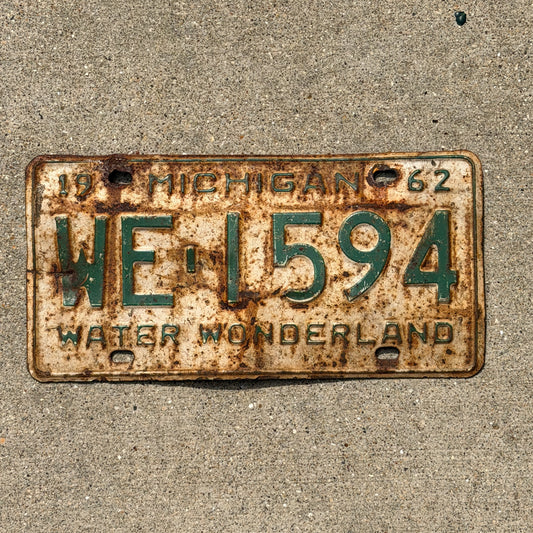 Photo of a 1962 Michigan License Plate Auto Tag Garage Decor Vintage WE 1594 with original patina