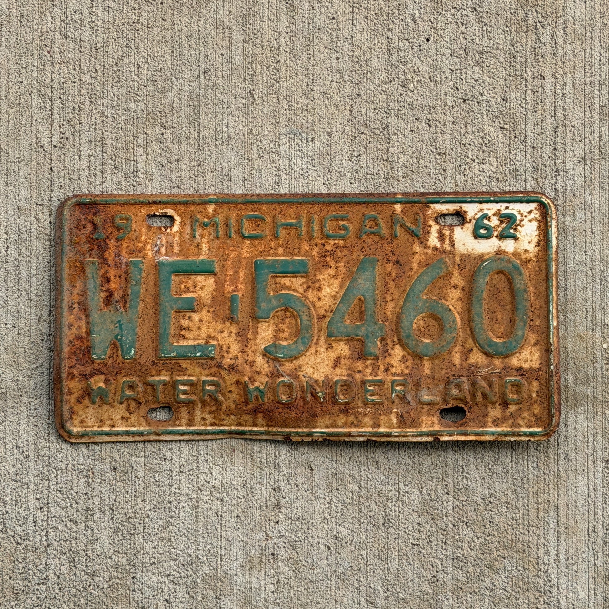 Photo of a 1962 Michigan License Plate Auto Tag Garage Decor Vintage WE 5460 with original patina