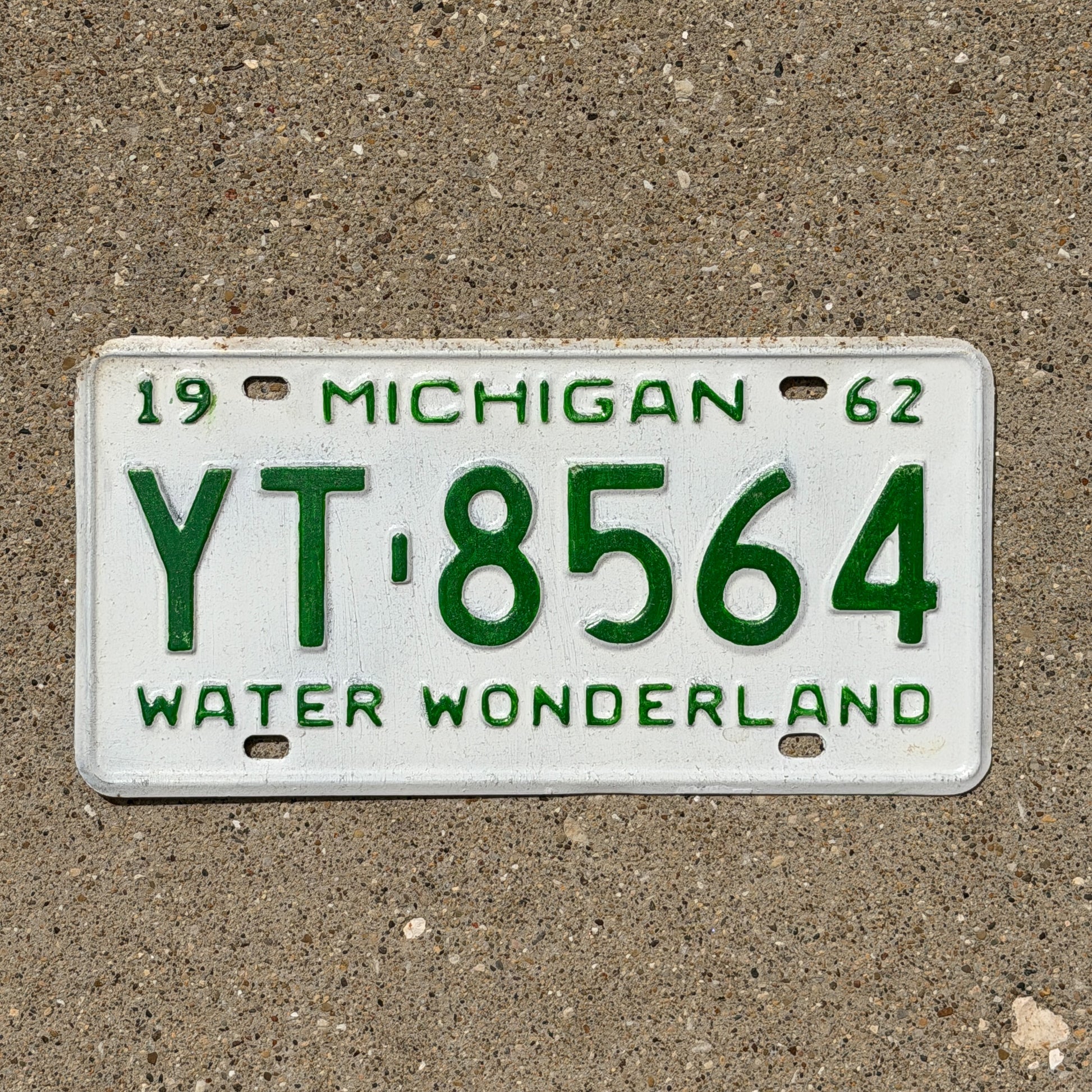 Photo of a 1962 Michigan License Plate Auto Tag Garage Decor Vintage YT 8564 with original patina
