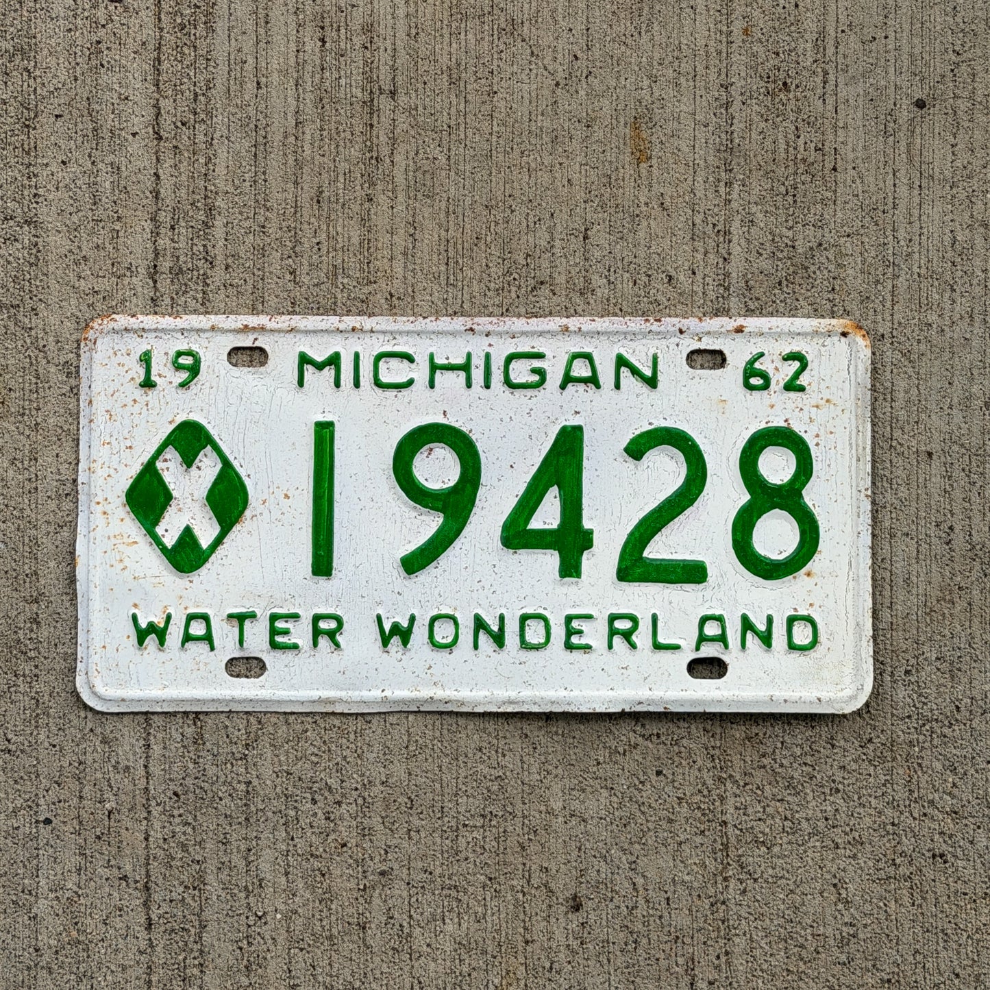 Photo of a 1962 Michigan Municipal License Plate Auto Tag Garage Decor Vintage 19428 with original patina