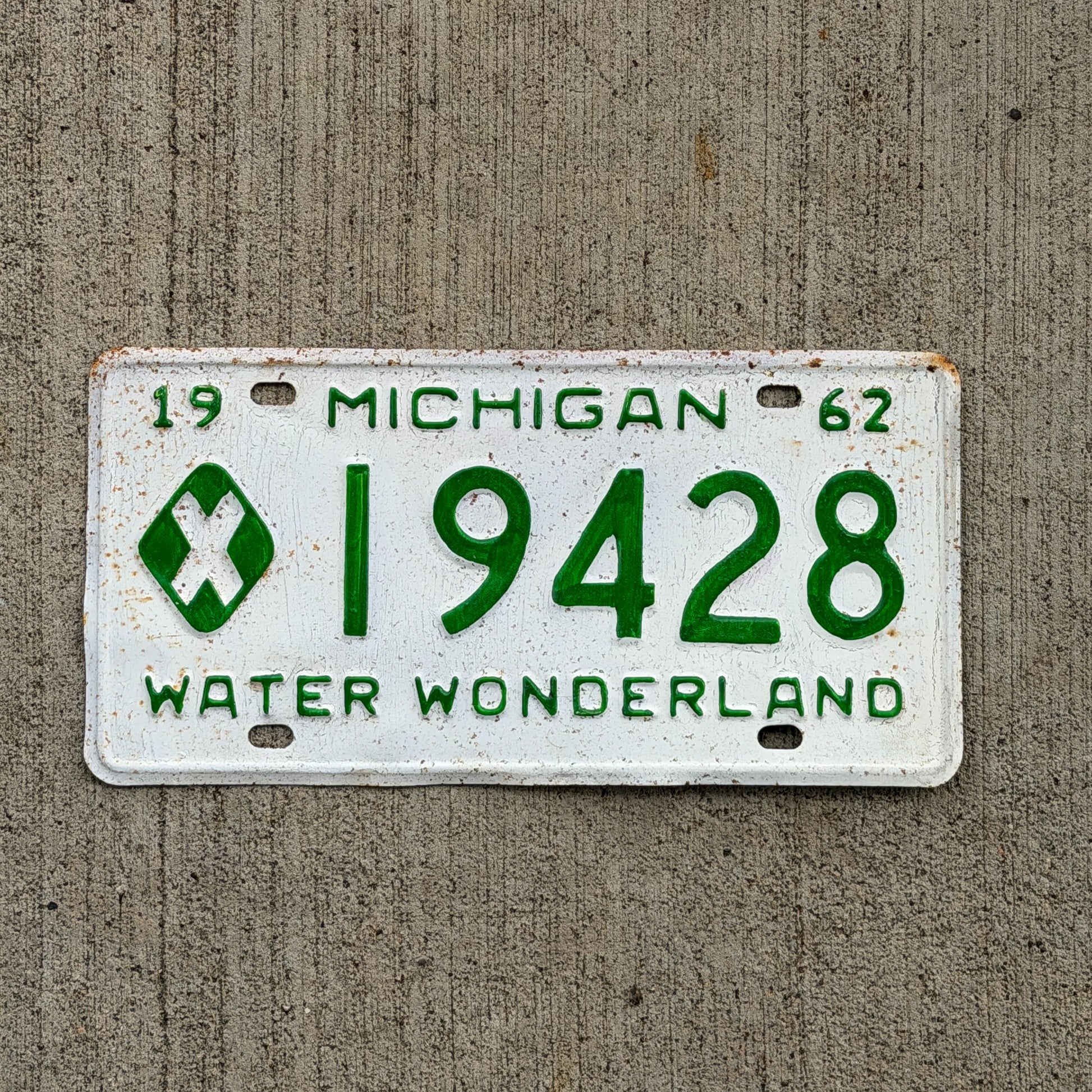 Photo of a 1962 Michigan Municipal License Plate Auto Tag Garage Decor Vintage 19428 with original patina