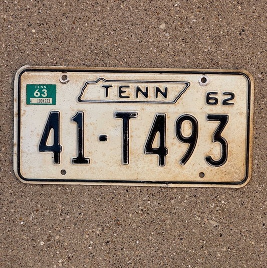 Vintage Tennessee license plate from 1962 on a concrete surface