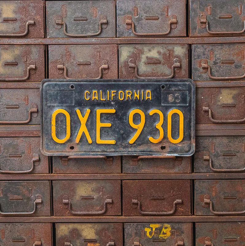 Photo of a 1963 California License Plate Auto Tag Garage Decor Vintage OXE 930 with original patina