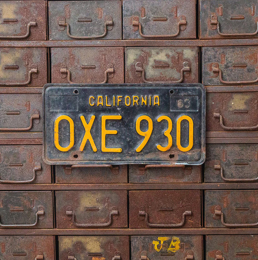 Photo of a 1963 California License Plate Auto Tag Garage Decor Vintage OXE 930 with original patina