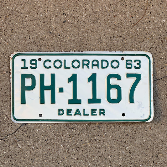Photo of a 1963 Colorado Dealer License Plate Auto Tag Garage Decor Vintage PH 1167 with original patina