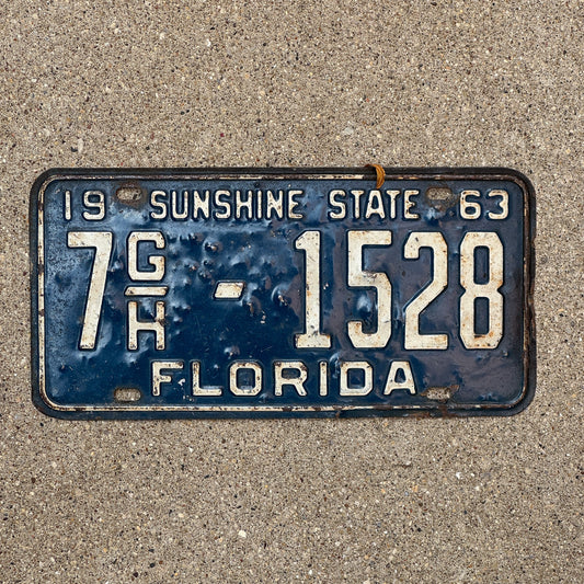 Photo of a 1963 Florida Commercial License Plate Auto Tag Garage Decor Vintage Orange County 7 GH 1528 with original patina
