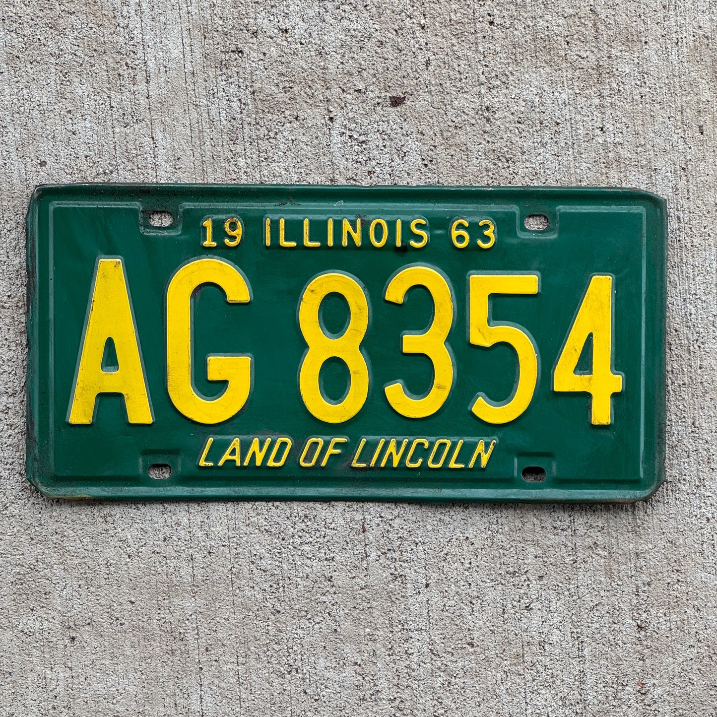 Photo of a 1963 Illinois License Plate Auto Tag 2 Vintage Garage AG 8354 with original patina