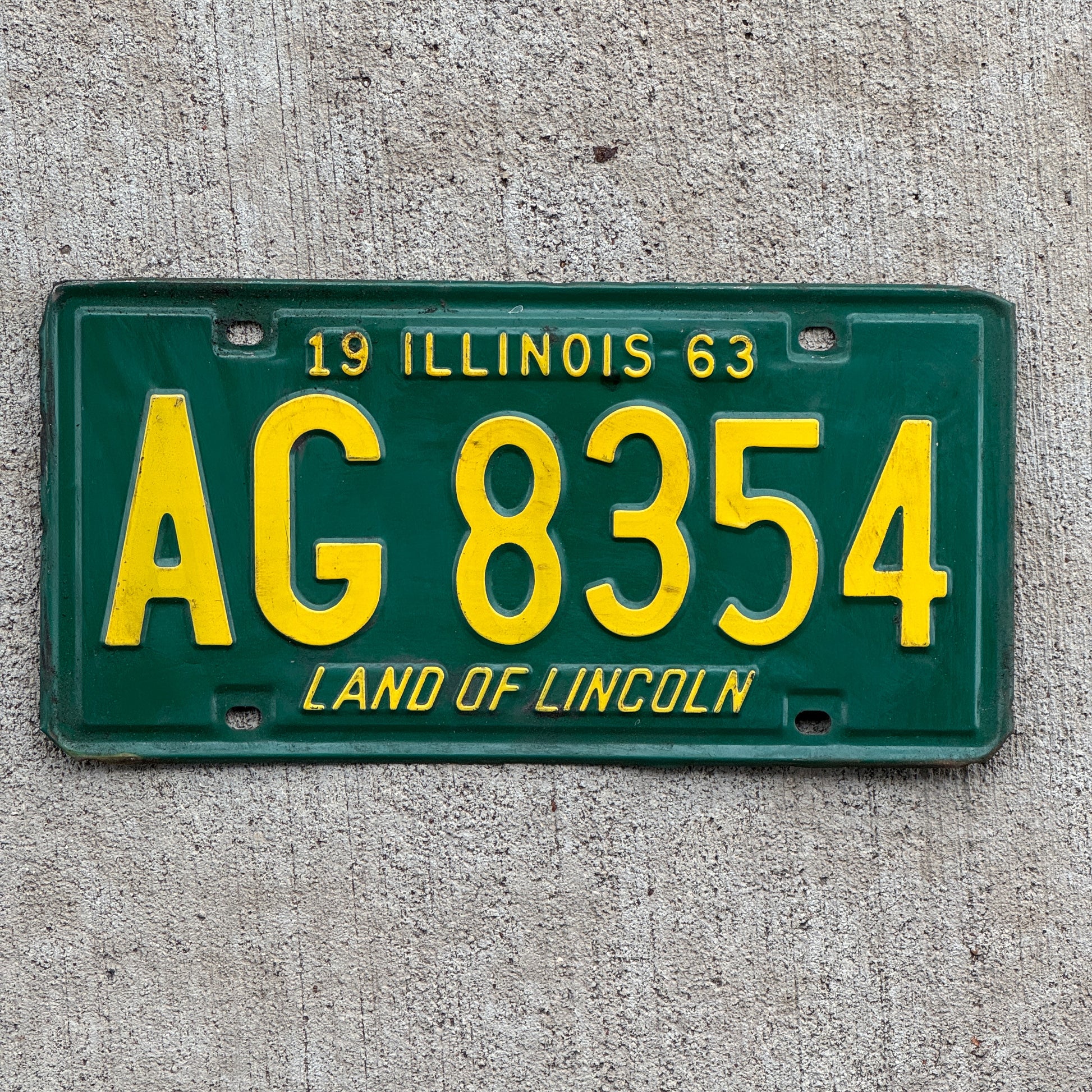 Photo of a 1963 Illinois License Plate Auto Tag 2 Vintage Garage AG 8354 with original patina