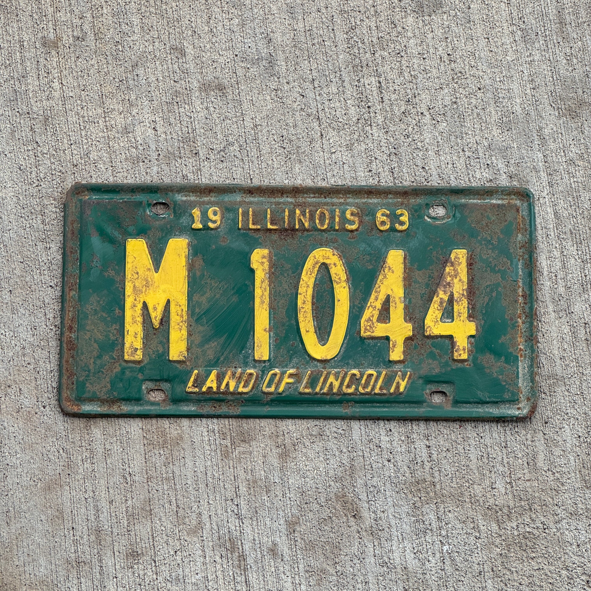 Photo of a 1963 Illinois Municipal License Plate Auto Tag 1 Vintage Garage M 1044 with original patina
