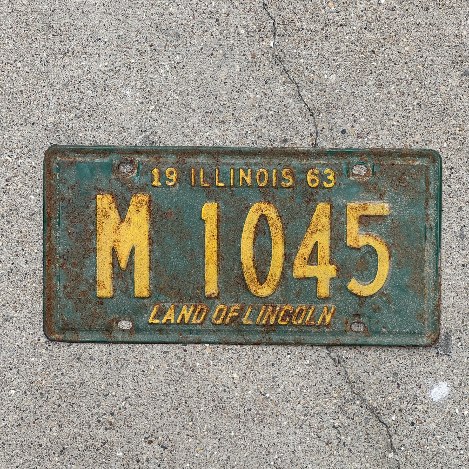 Photo of a 1963 Illinois Municipal License Plate Auto Tag 1 Vintage Garage M 1045 with original patina