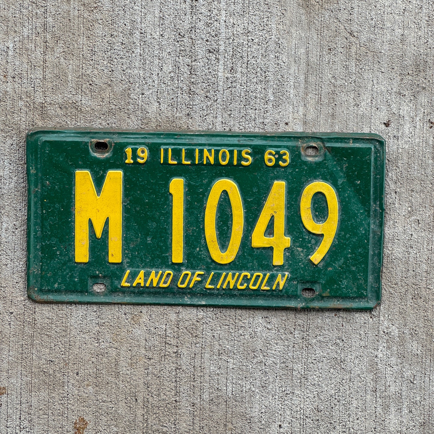 Photo of a 1963 Illinois Municipal License Plate Auto Tag 1 Vintage Garage M 1049 with original patina