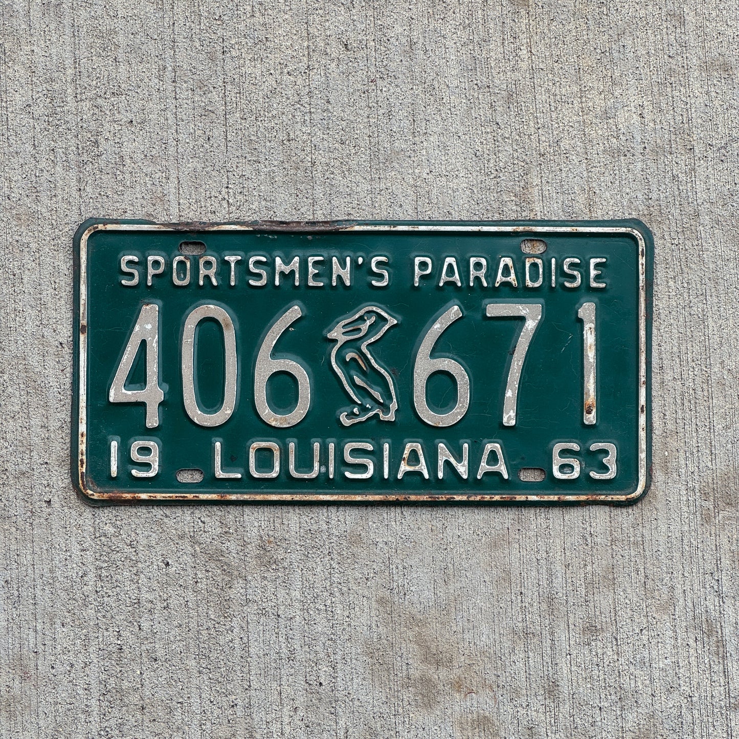 Photo of a 1963 Louisiana License Plate Auto Tag Garage Decor Vintage Iconic Pelican 406 671 with original patina