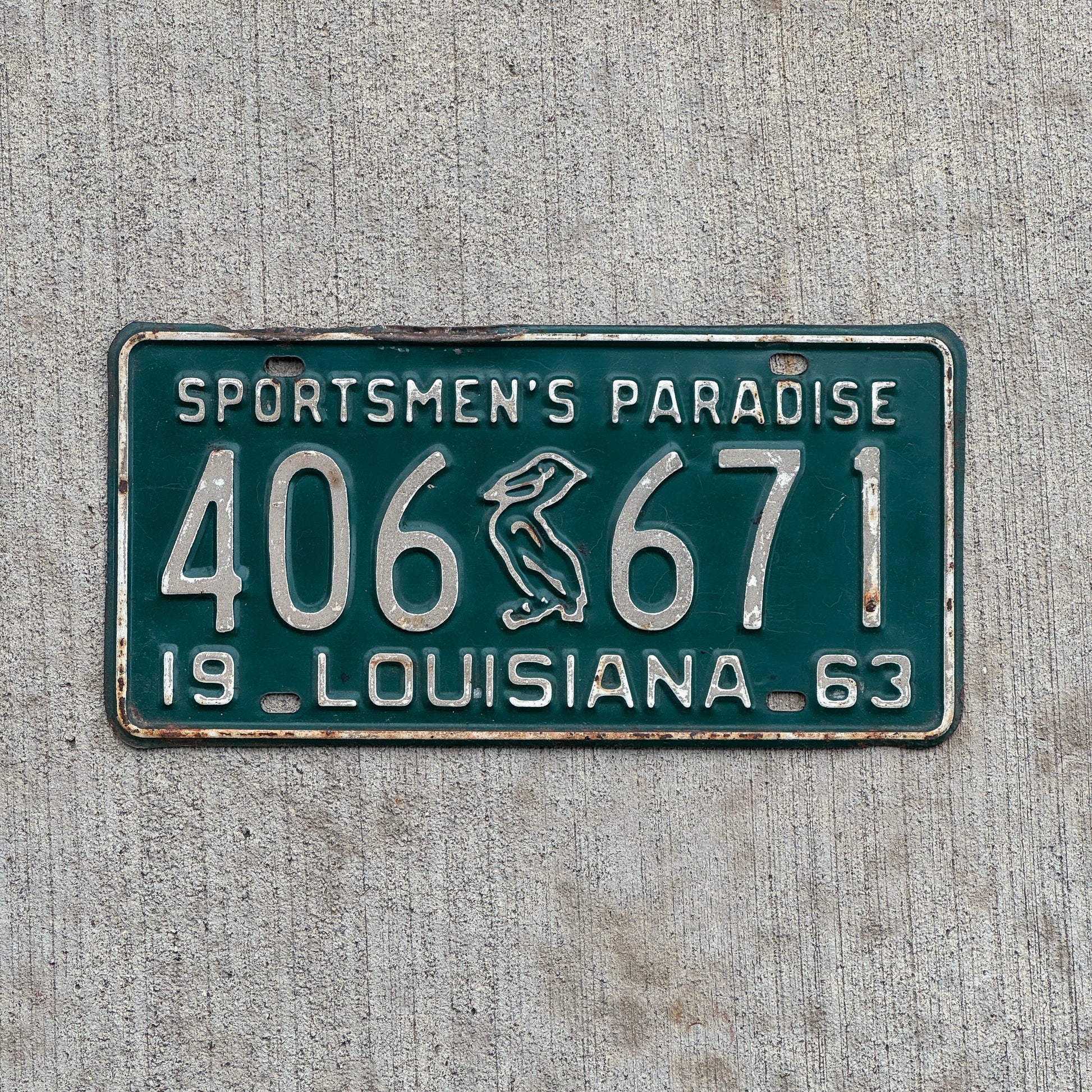 Photo of a 1963 Louisiana License Plate Auto Tag Garage Decor Vintage Iconic Pelican 406 671 with original patina