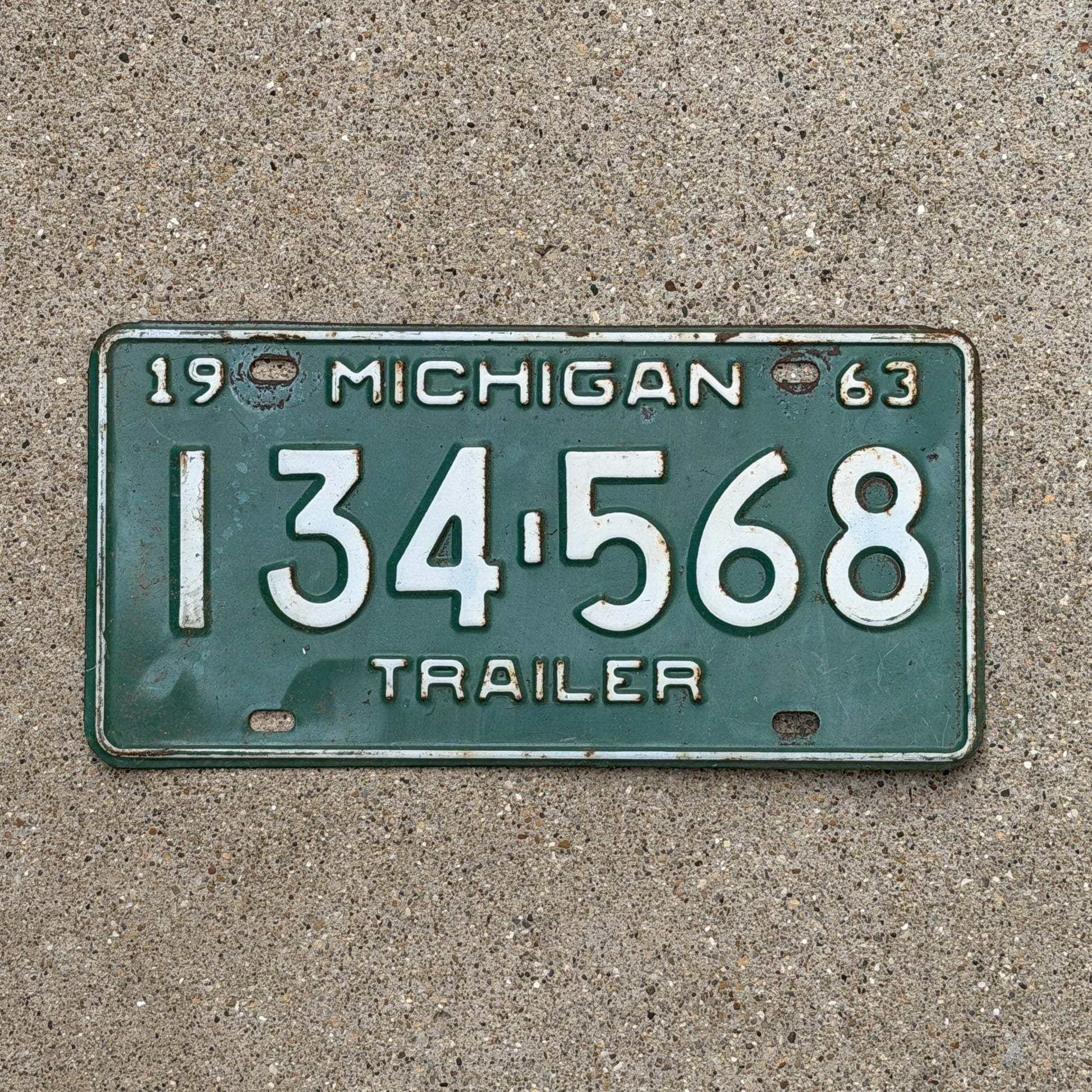 Photo of a 1963 Michigan Trailer License Plate Auto Tag Garage Decor Vintage 134 568 with original patina