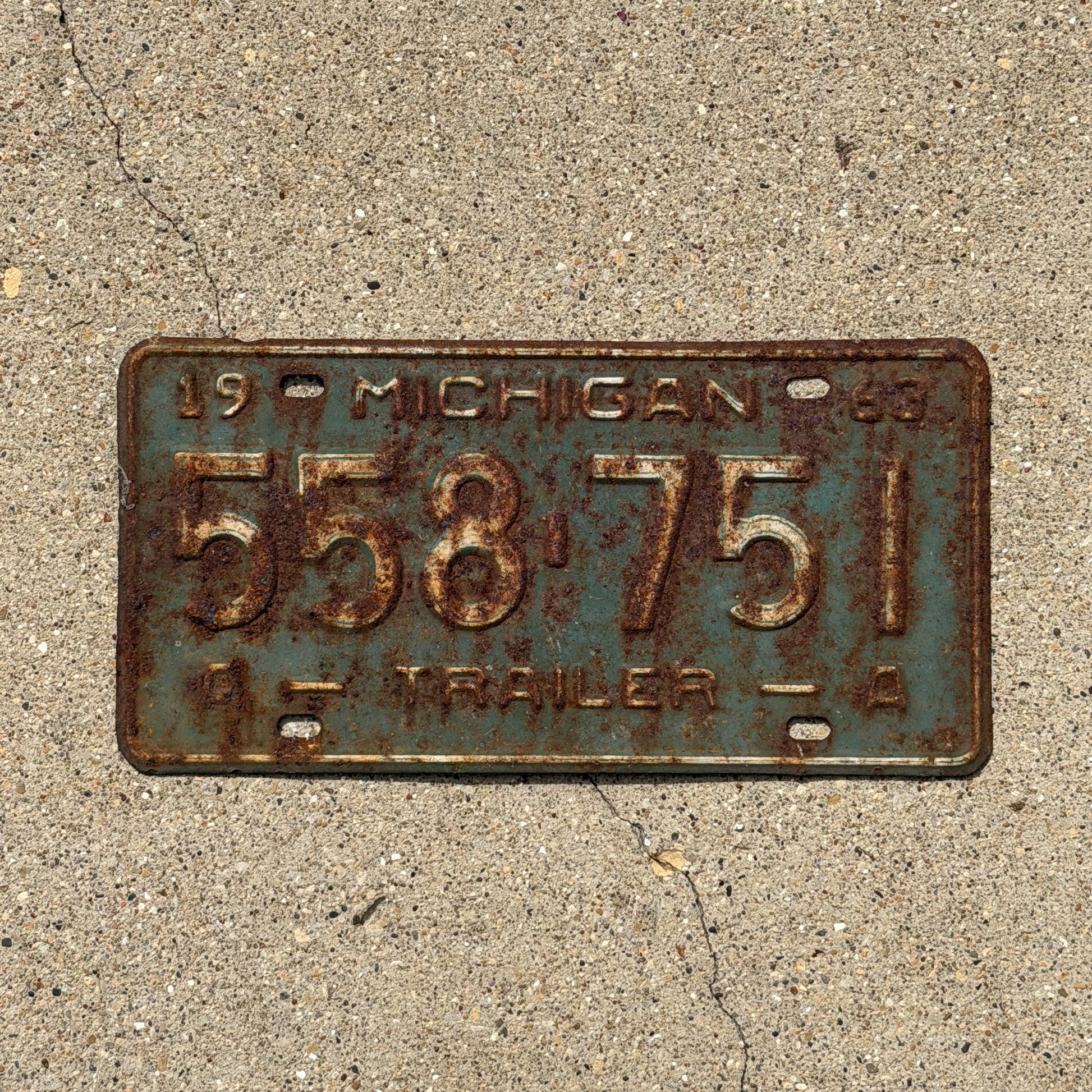 Photo of a 1963 Michigan Trailer License Plate Auto Tag Garage Decor Vintage 558 751 with original patina