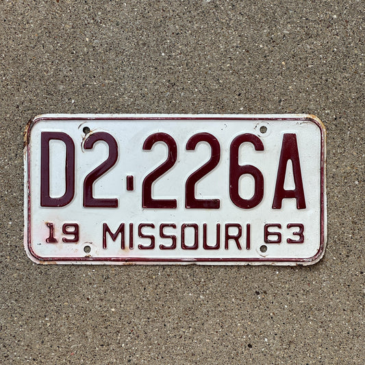 Photo of a 1963 Missouri Dealer License Plate Auto Tag Garage Decor Vintage Repeat Repeating D 222 6A