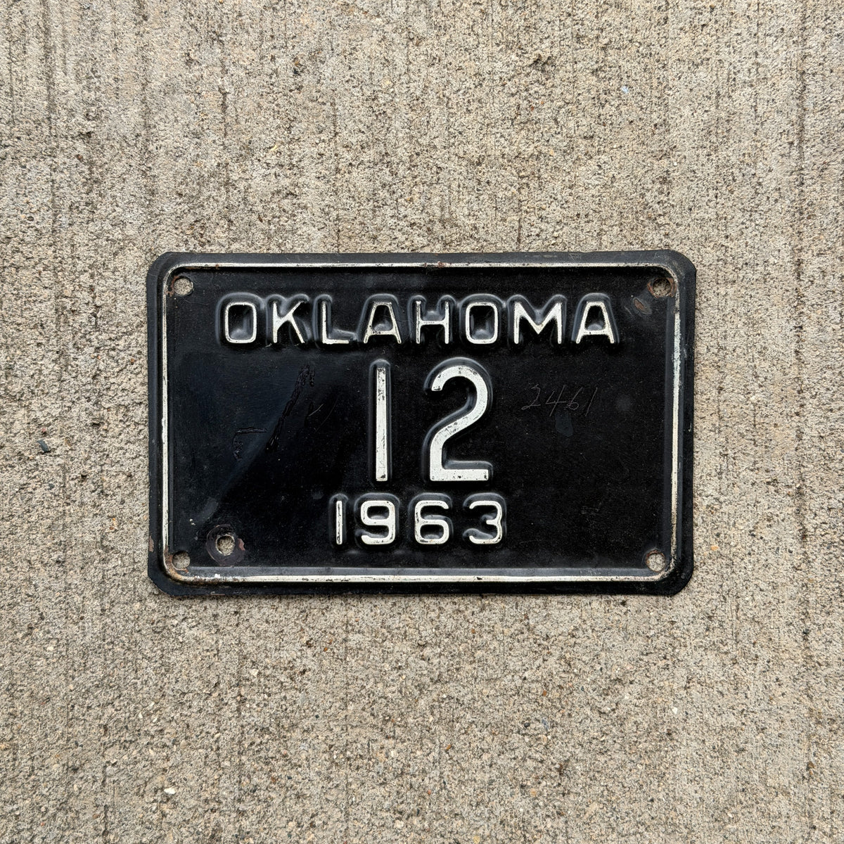 Photo of a 1963 Oklahoma Police Motorcycle License Plate Auto Tag Garage Decor Vintage Low Number Two Digit OKC Cop 12 with original patina