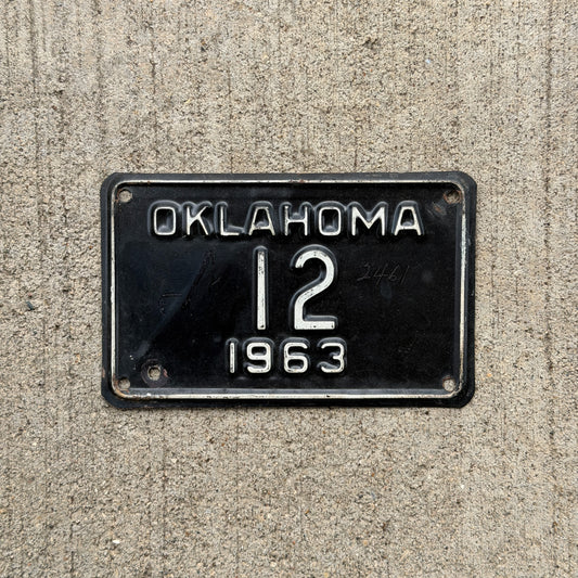 Photo of a 1963 Oklahoma Police Motorcycle License Plate Auto Tag Garage Decor Vintage Low Number Two Digit OKC Cop 12 with original patina