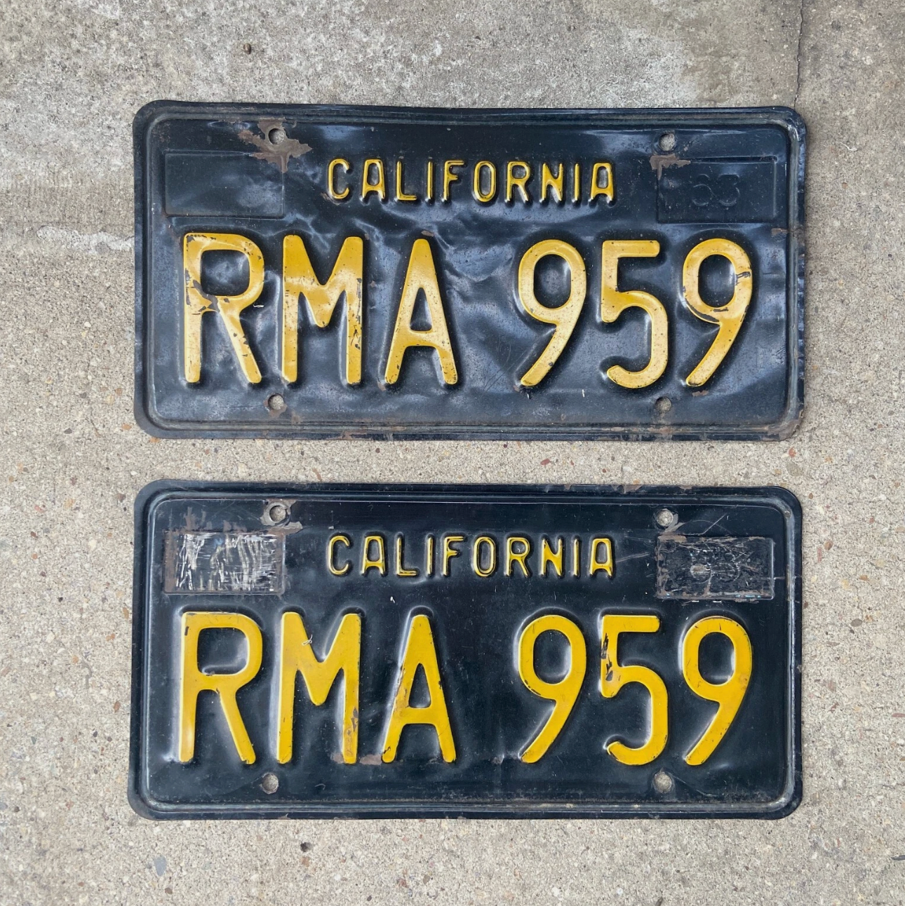 1963 California License plates number RMA959 on a concrete background.