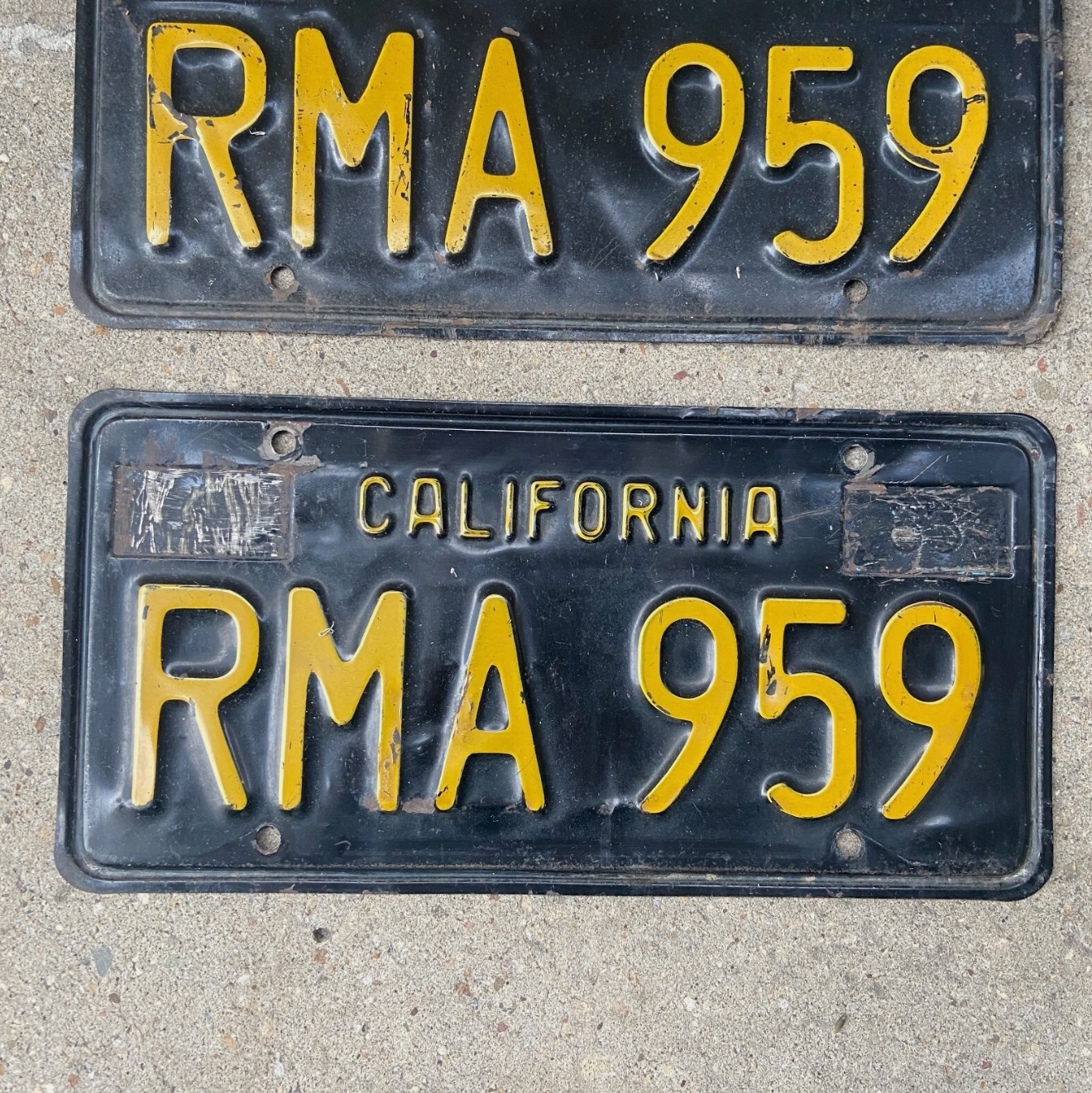 1963 California License plate number RMA959 on a concrete background.