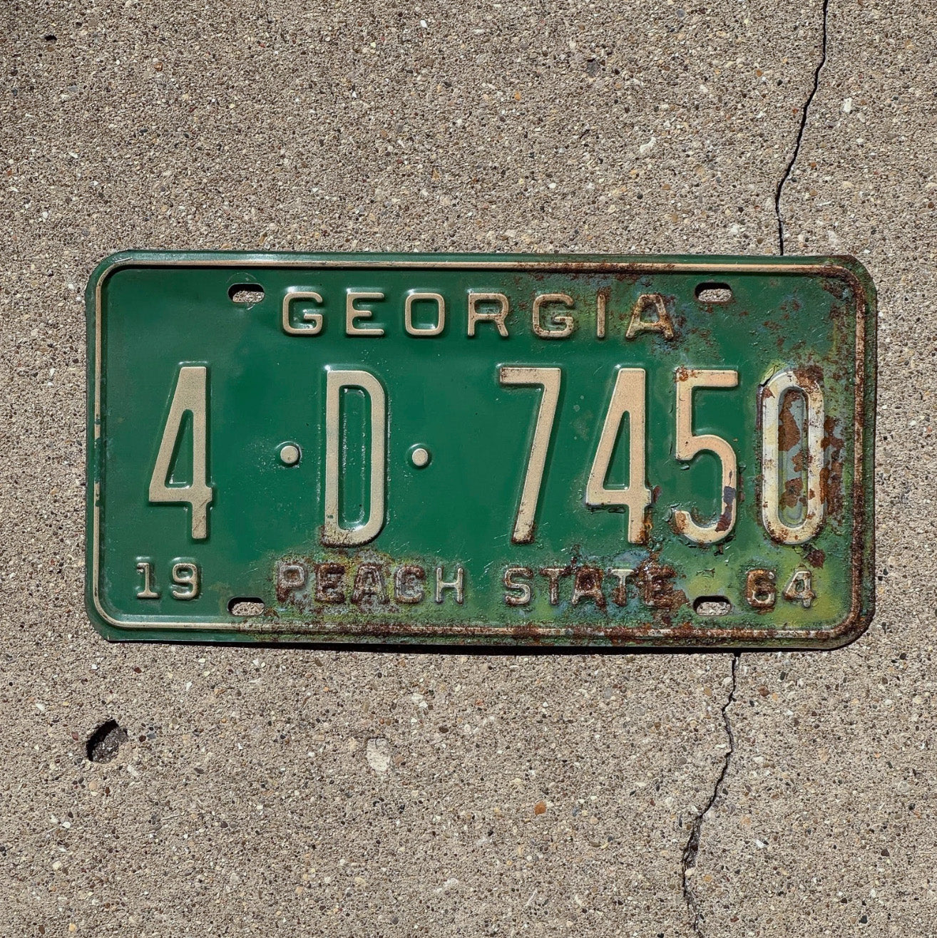 Photo of a 1964 Georgia License Plate Auto Tag Garage Decor Vintage 4D 7450 with original patina