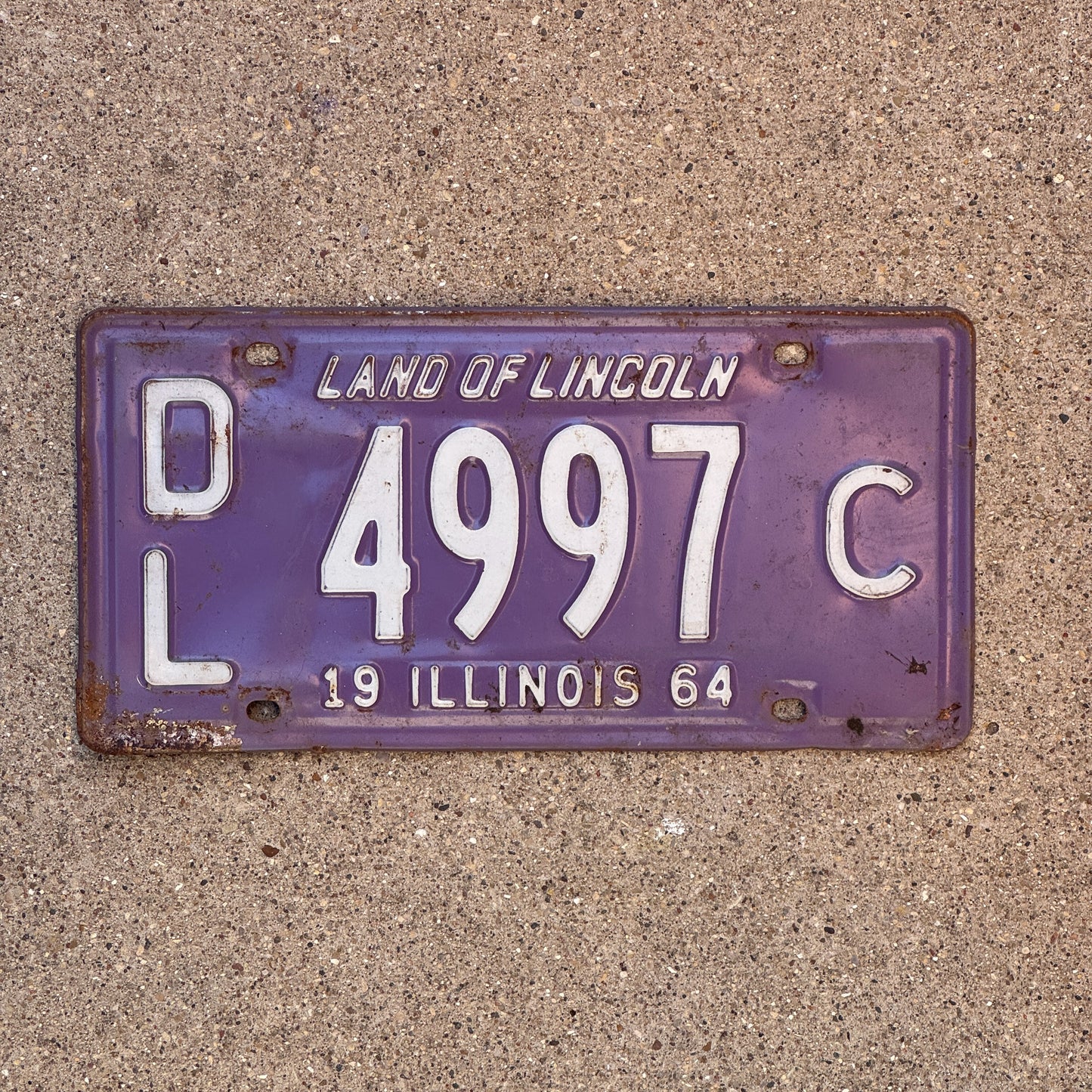 Photo of a 1964 Illinois Dealer License Plate Auto Tag 2 Vintage Garage Purple 4997 C with original patina