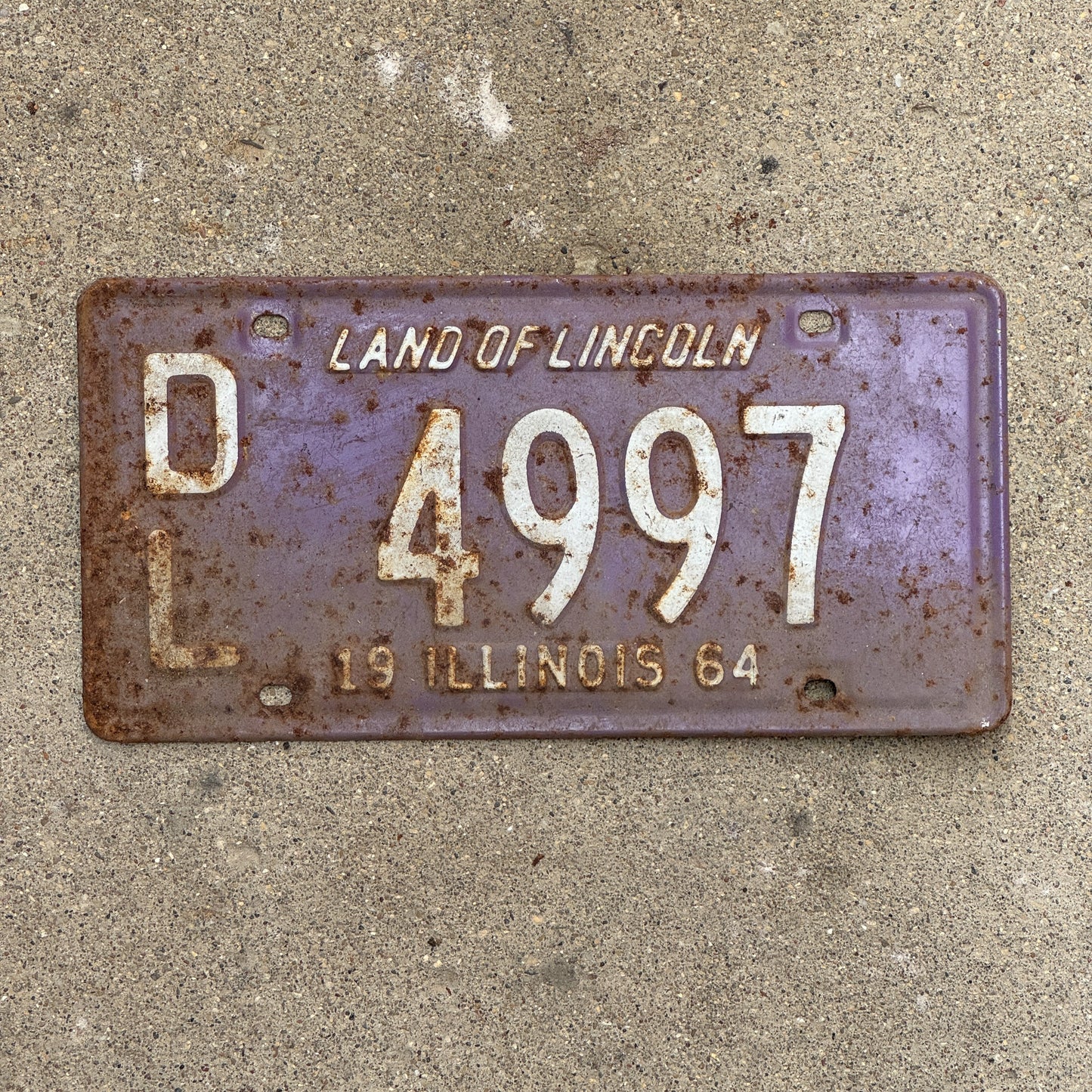 Photo of a 1964 Illinois Dealer License Plate Auto Tag Garage Decor Vintage Purple 4997 with original patina
