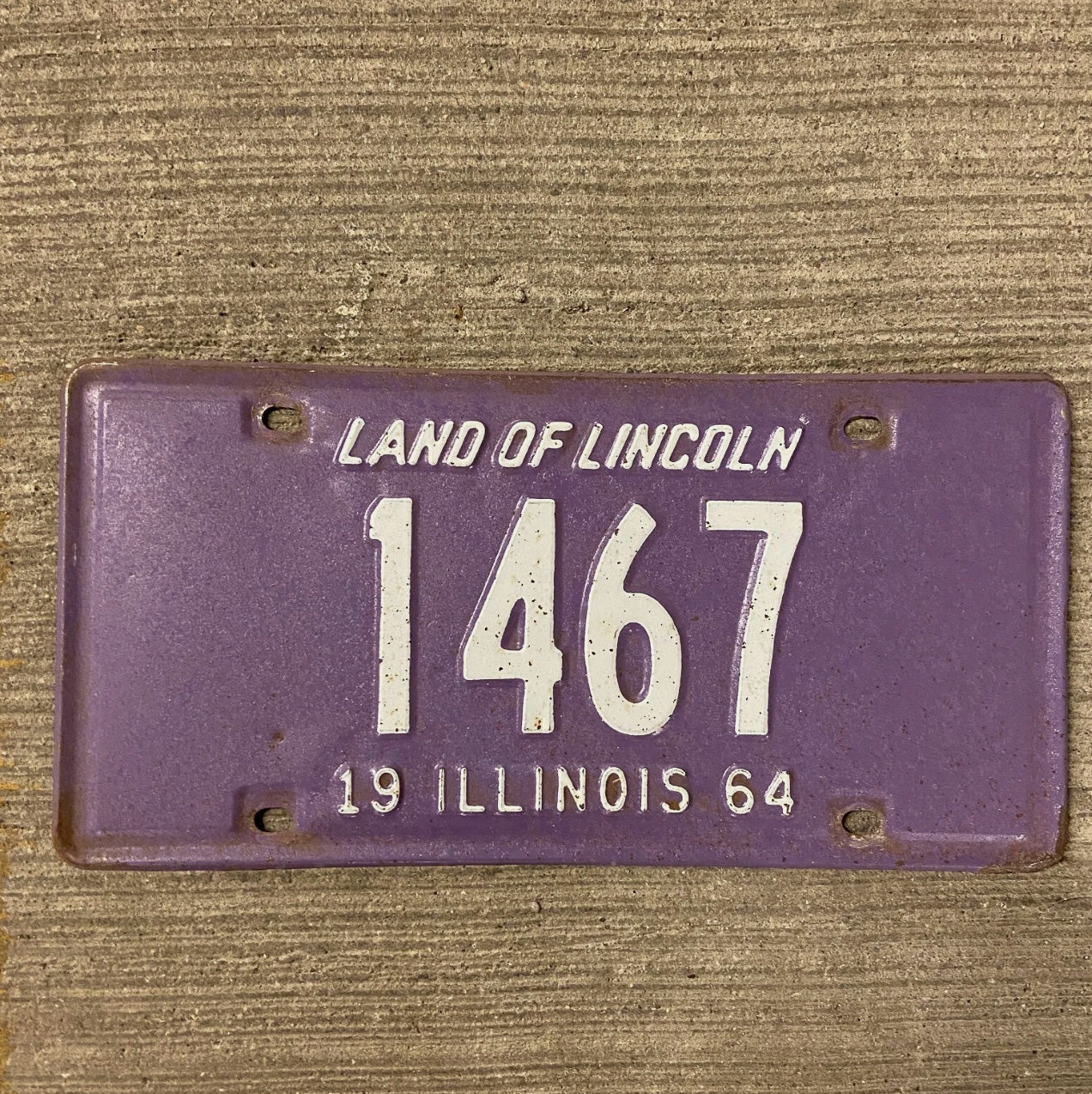 Photo of a 1964 Illinois License Plate Auto Tag Garage Decor Vintage Purple Low Number Four Digit 1467 with original patina