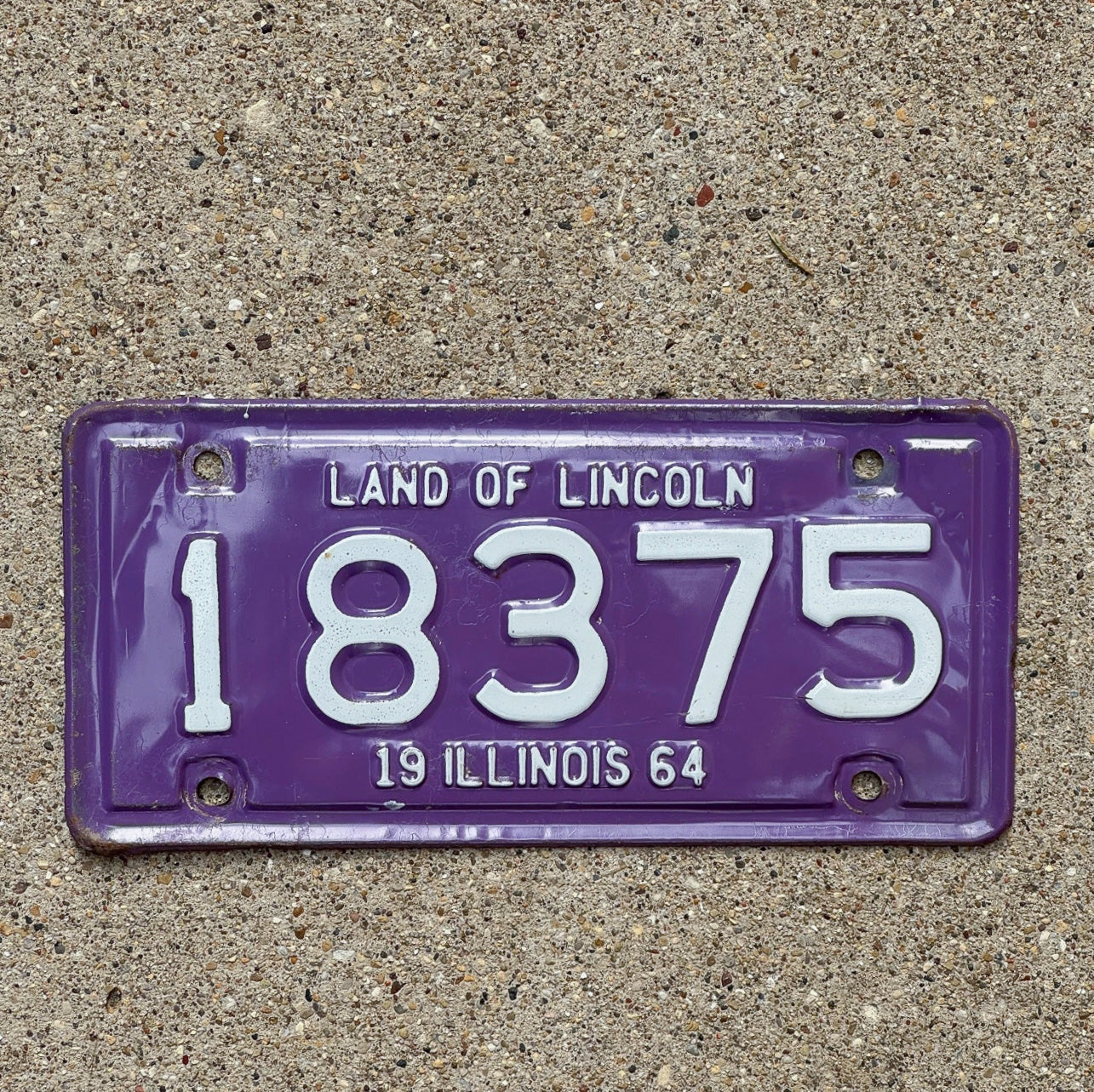 Photo of a 1964 Illinois Motorcycle License Plate Auto Tag Garage Decor Vintage Purple 18375 with original patina
