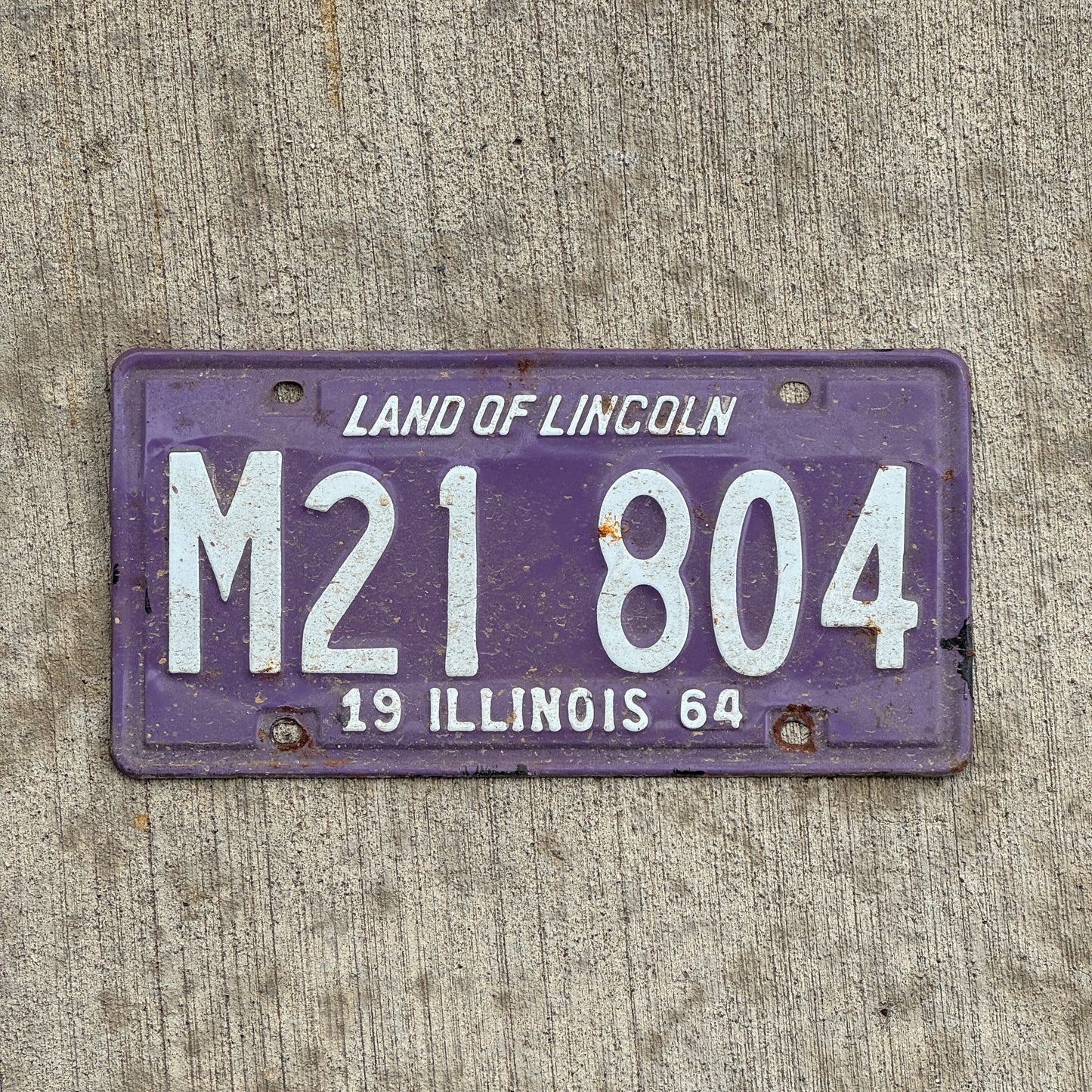 Photo of a 1964 Illinois Municipal License Plate Auto Tag 1 Vintage Garage Purple M 21 804 with original patina
