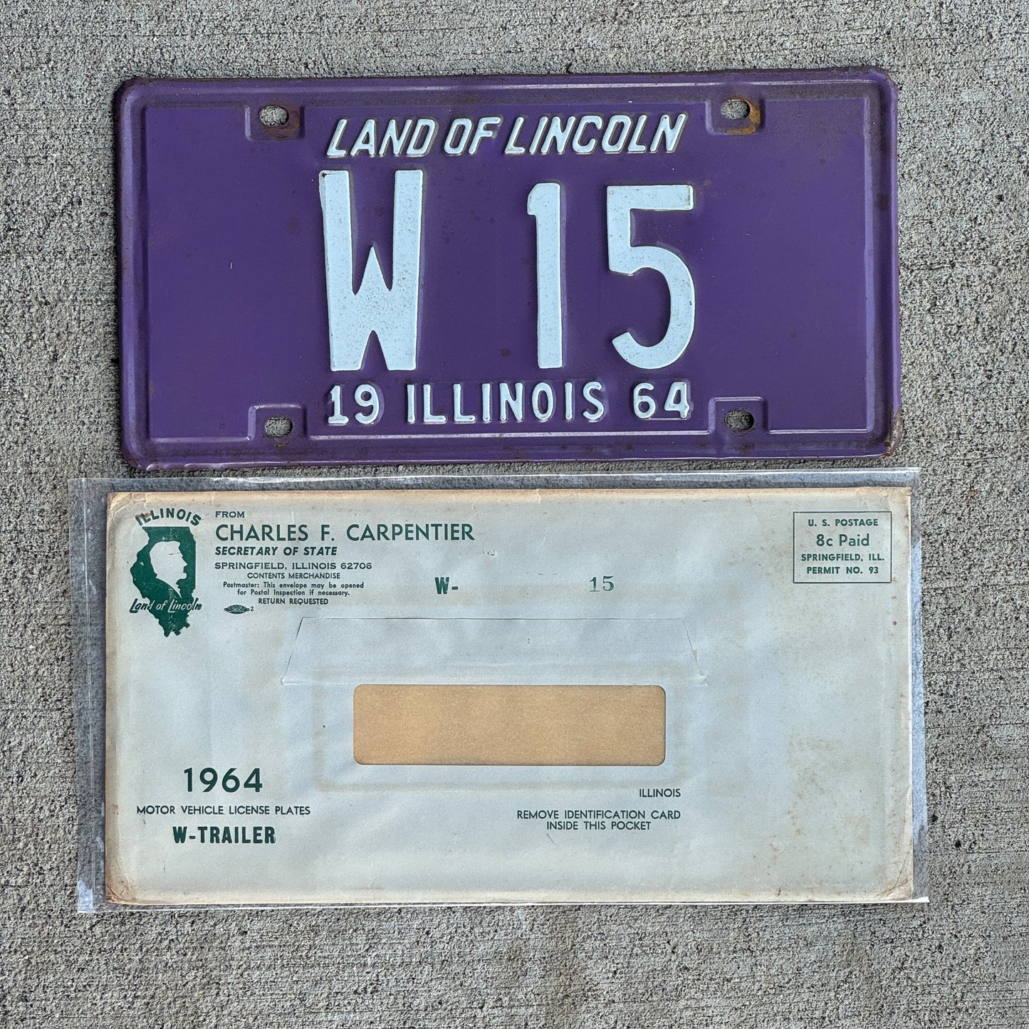 Photo of a 1964 Illinois Trailer License Plate Auto Tag Garage Decor Vintage Low Number Two Digit with Envelope W 15 with original patina
