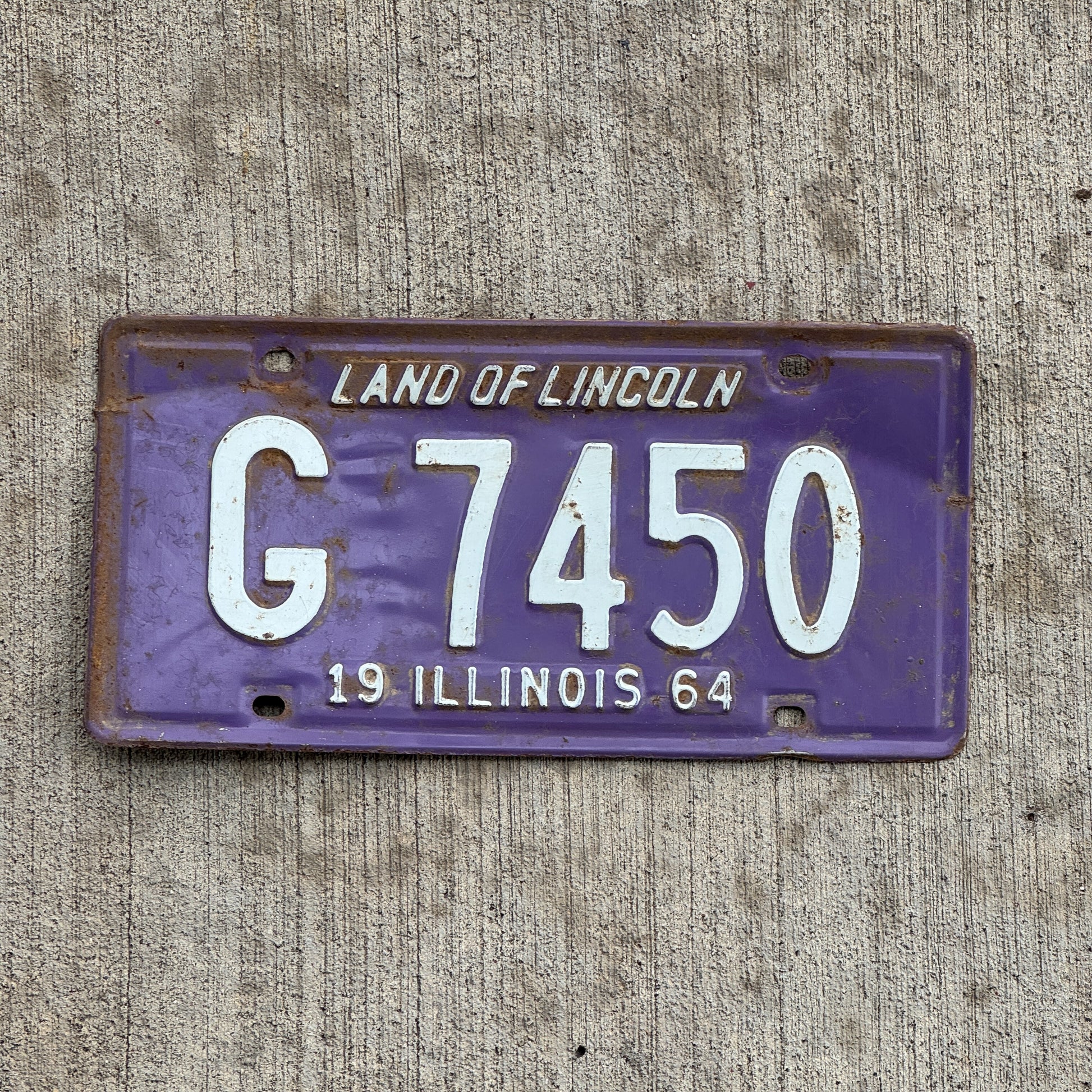 Photo of a 1964 Illinois Truck License Plate Auto Tag Garage Decor Vintage Purple G 7450 with original patina