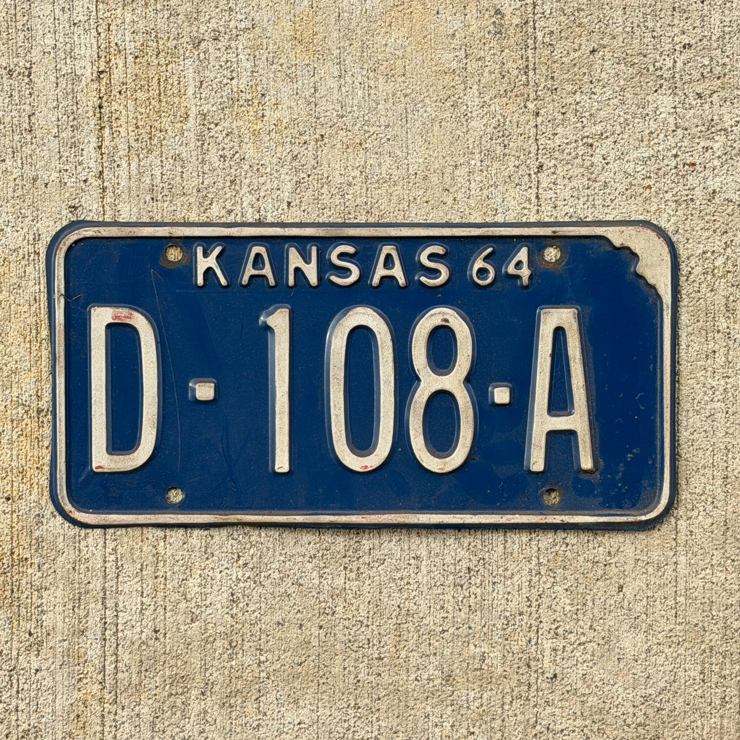 Photo of a 1964 Kansas Dealer License Plate Auto Tag Garage Decor Vintage D 108 A with original patina