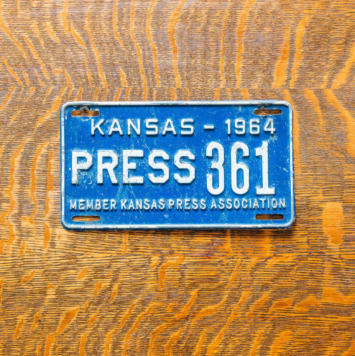 Photo of a 1964 Kansas Press License Plate Auto Tag Garage Decor Vintage TV Media Newspaper 361 with original patina